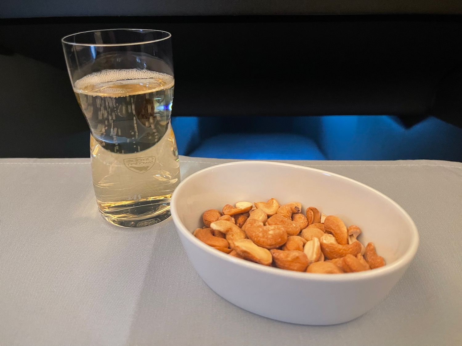 a bowl of nuts and a glass of liquid