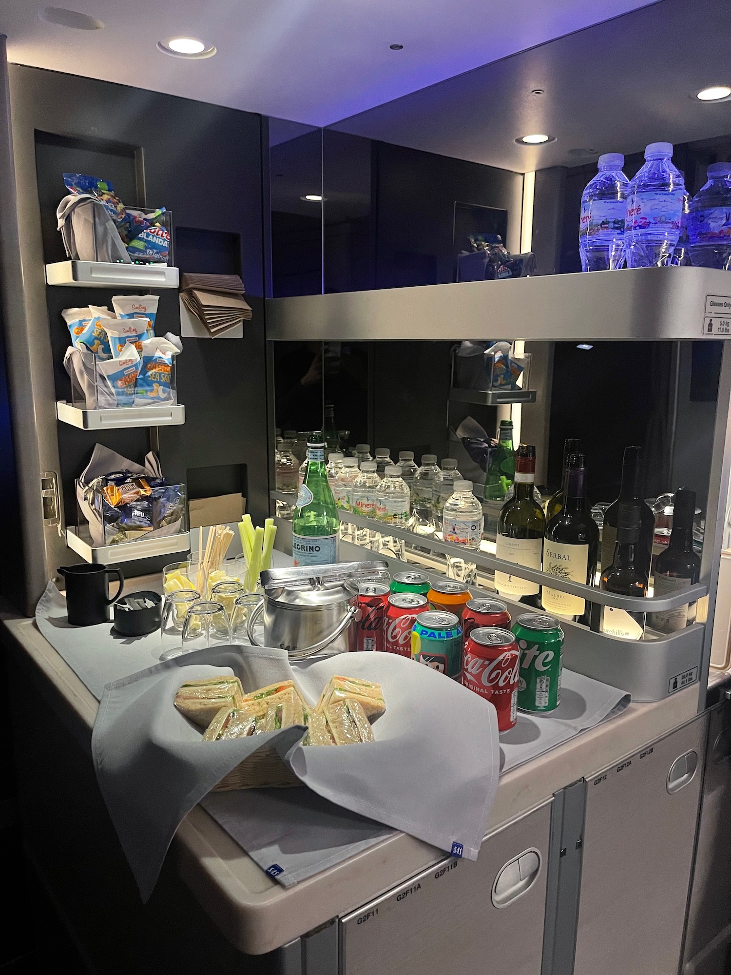 a shelf with drinks and snacks on it