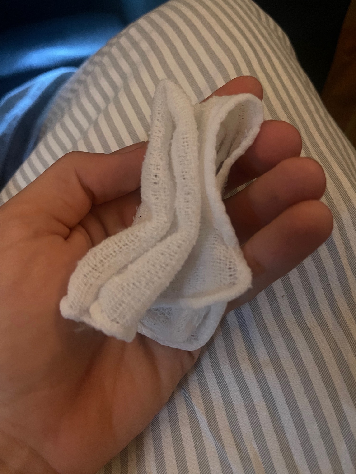 a hand holding a white sock