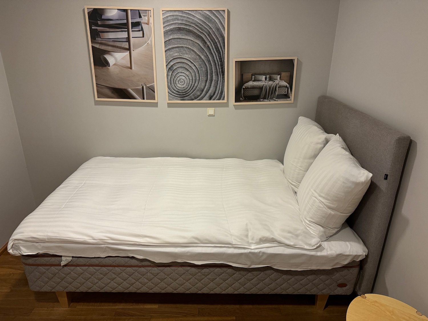 a bed with white sheets and pillows
