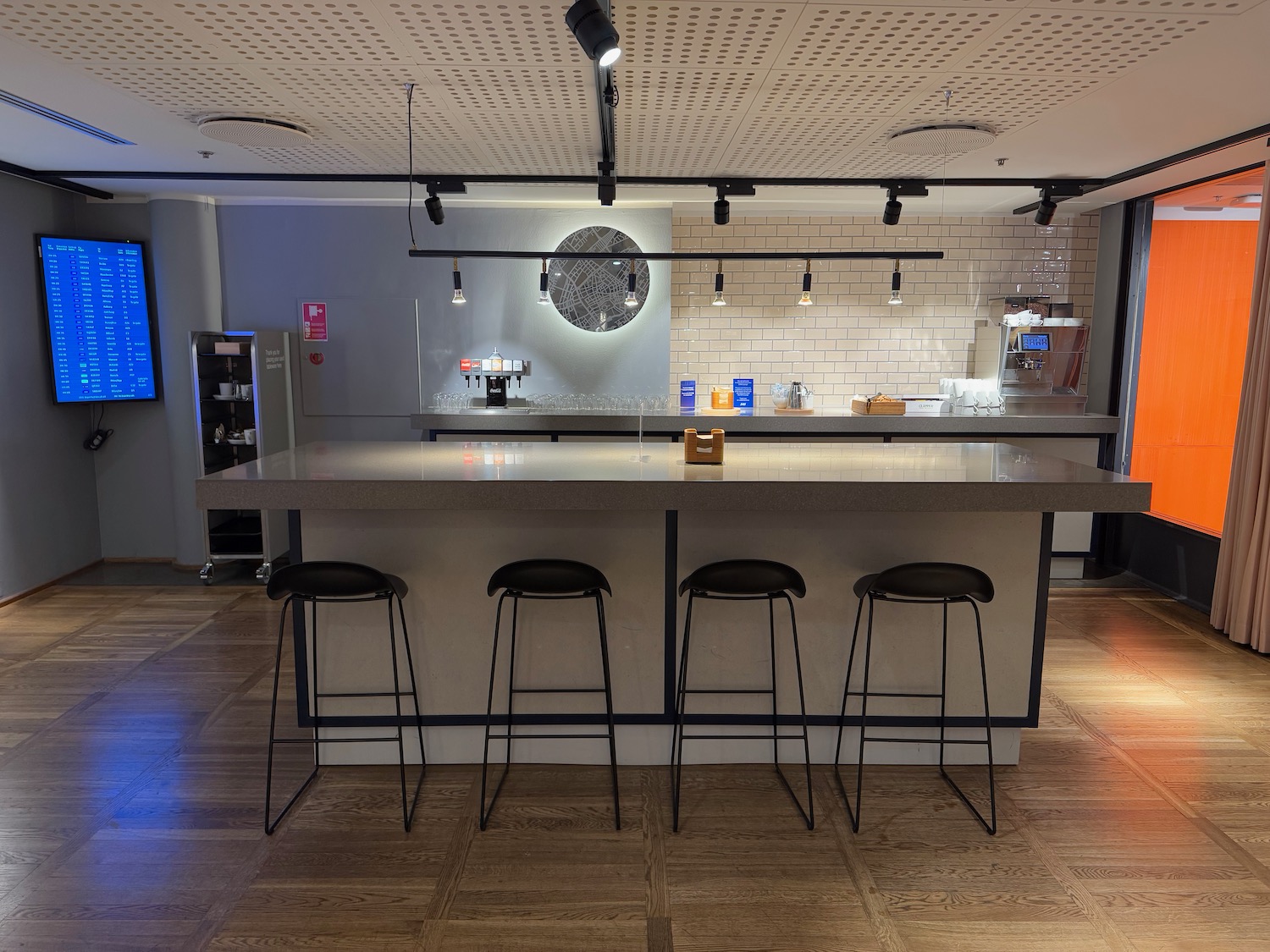 a bar with stools and lights