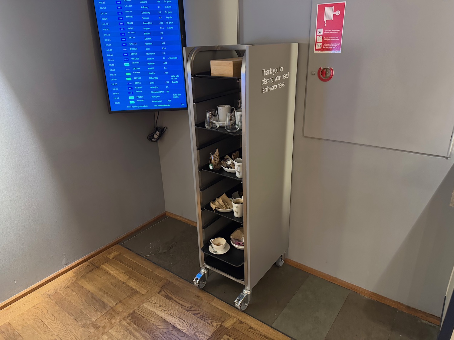 a cart with a tray of tea cups and cups on wheels