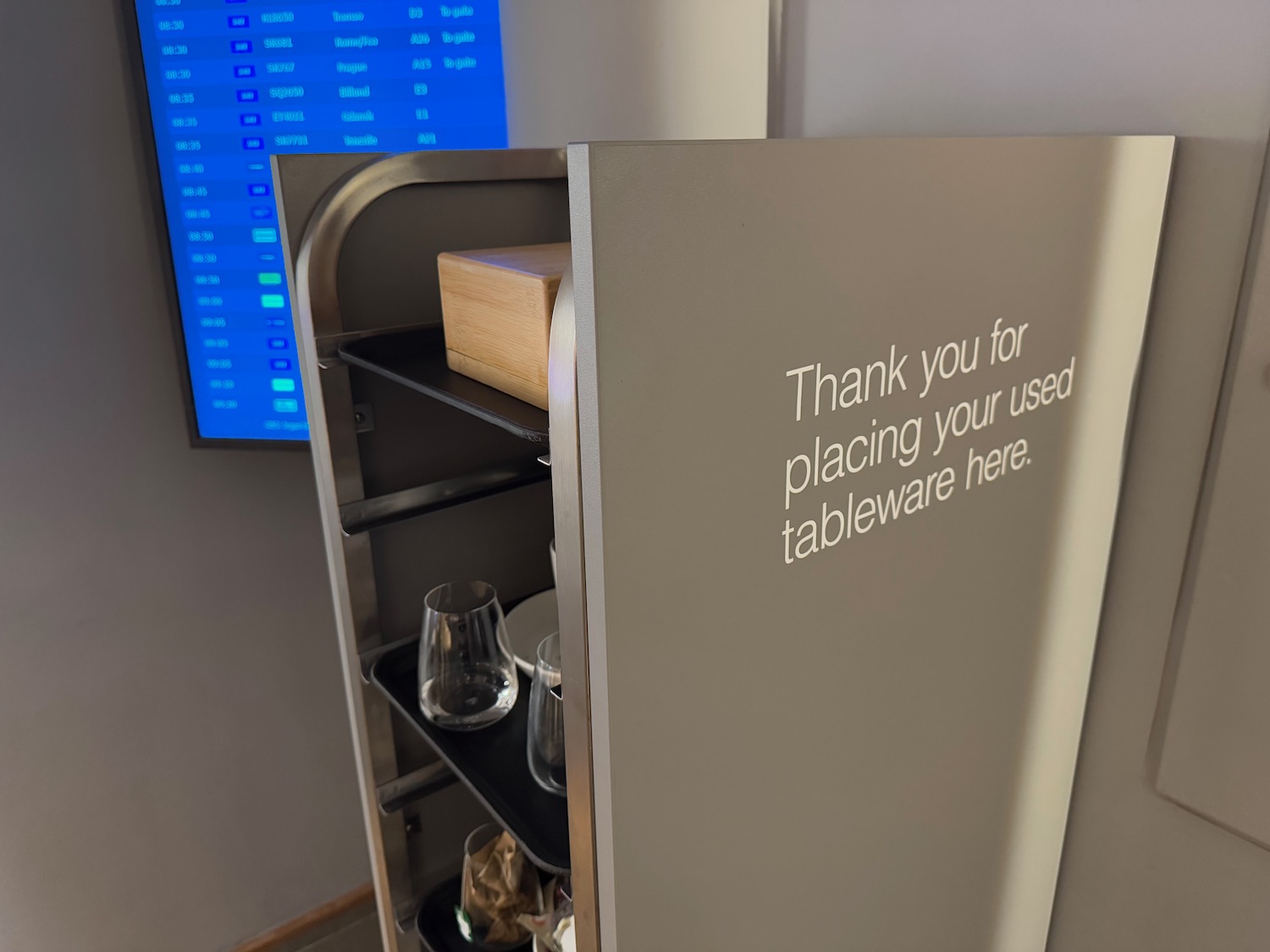 a grey metal shelf with a sign on it