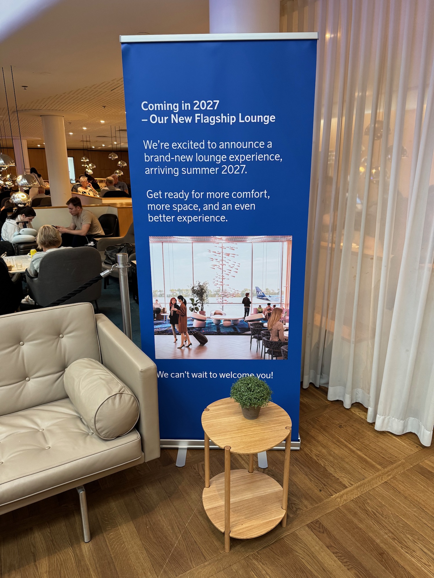 a blue sign with a picture of people sitting in a room