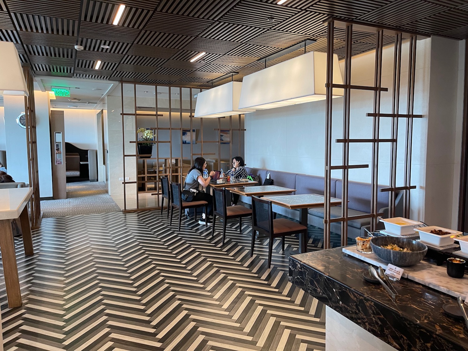 a group of people sitting at tables in a restaurant