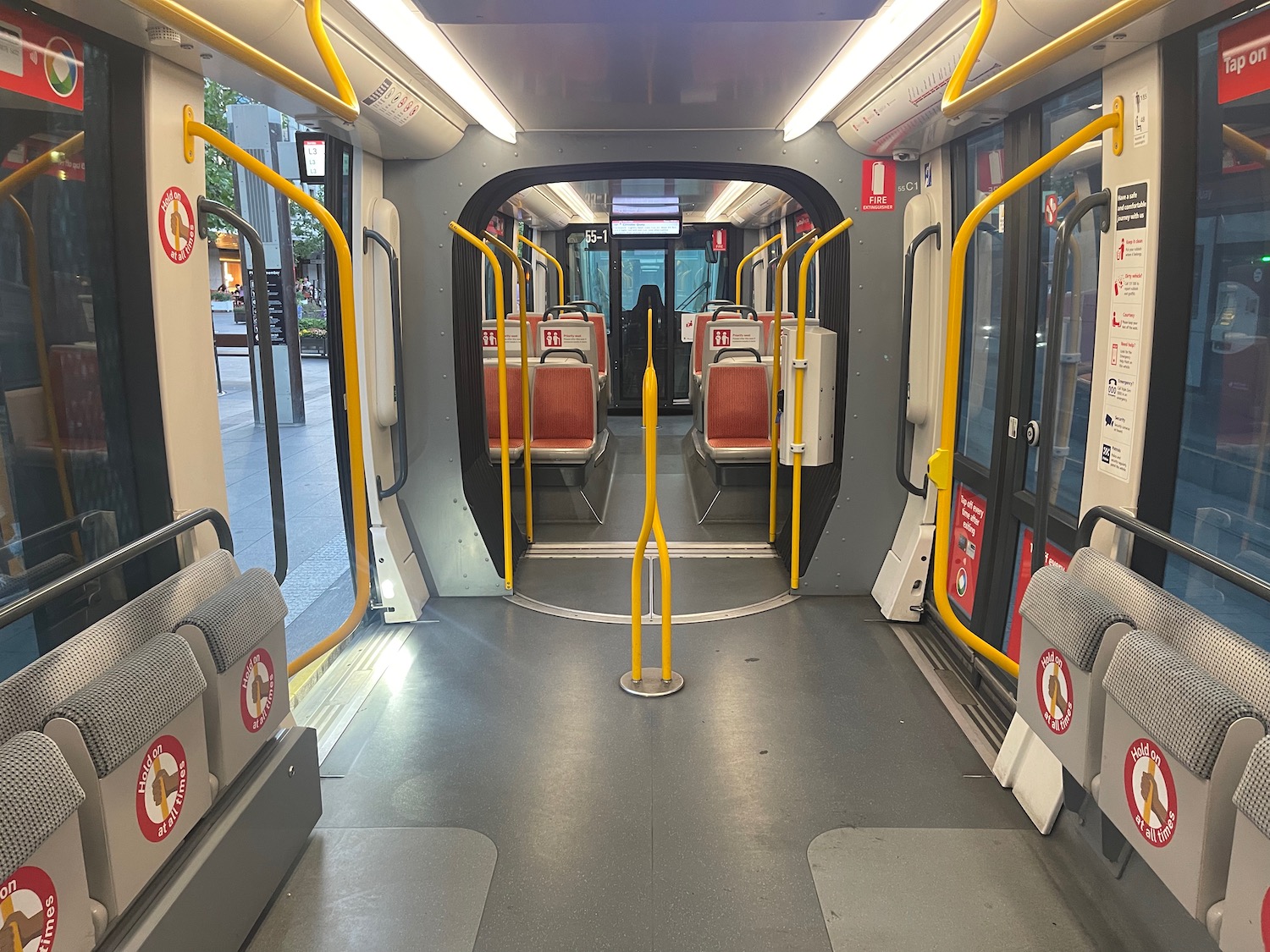 inside a bus with yellow handrails