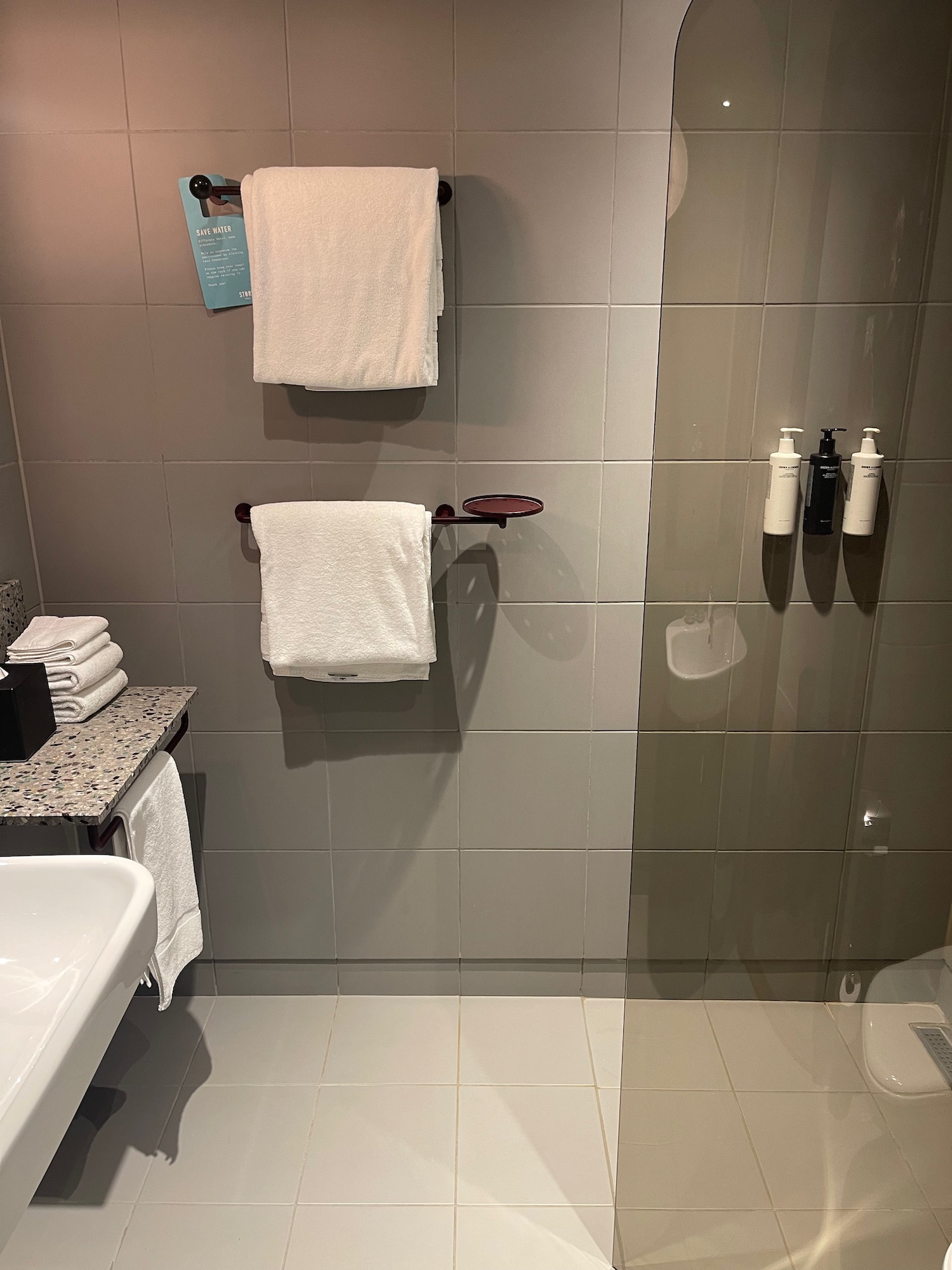 a bathroom with white towels and a sink