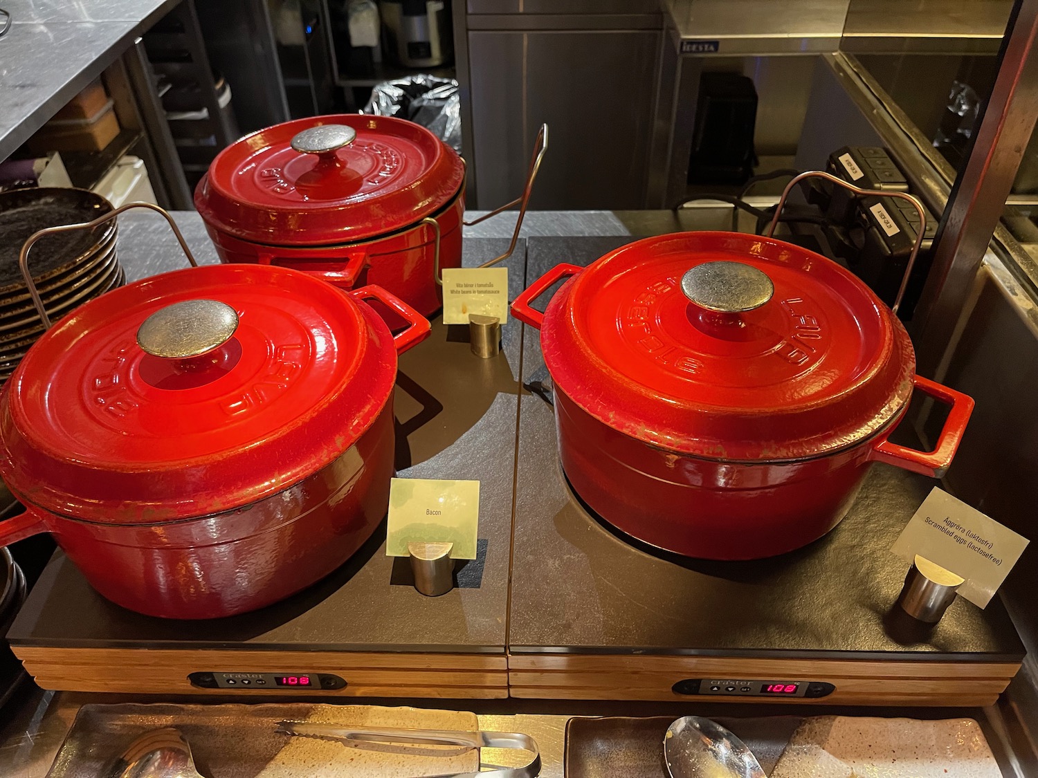 a group of red pots on a counter