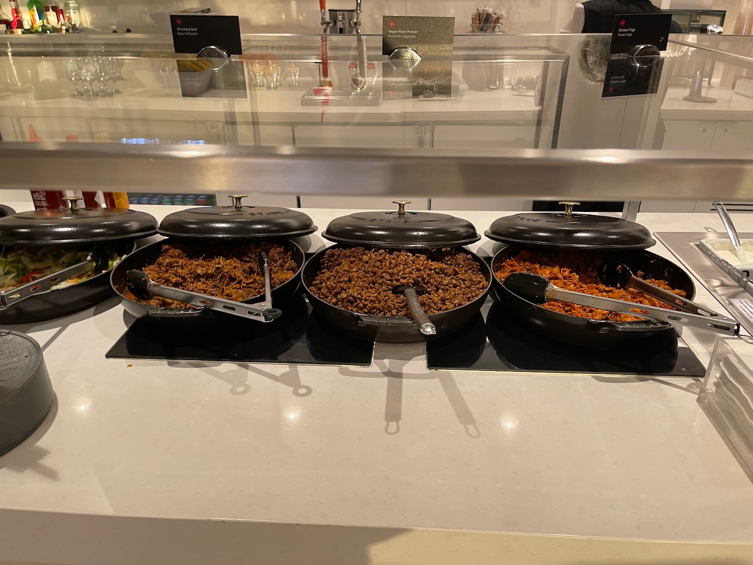 a row of pans with food in them