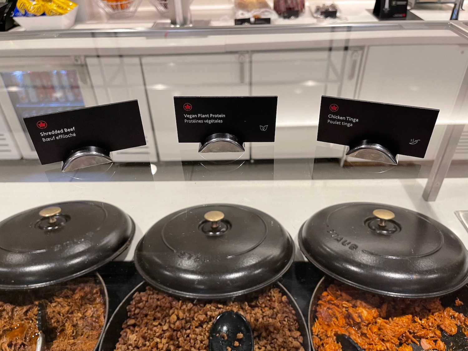 food in a buffet with signs