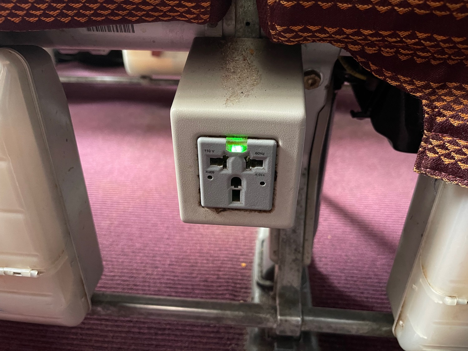 an electrical outlet with a green light