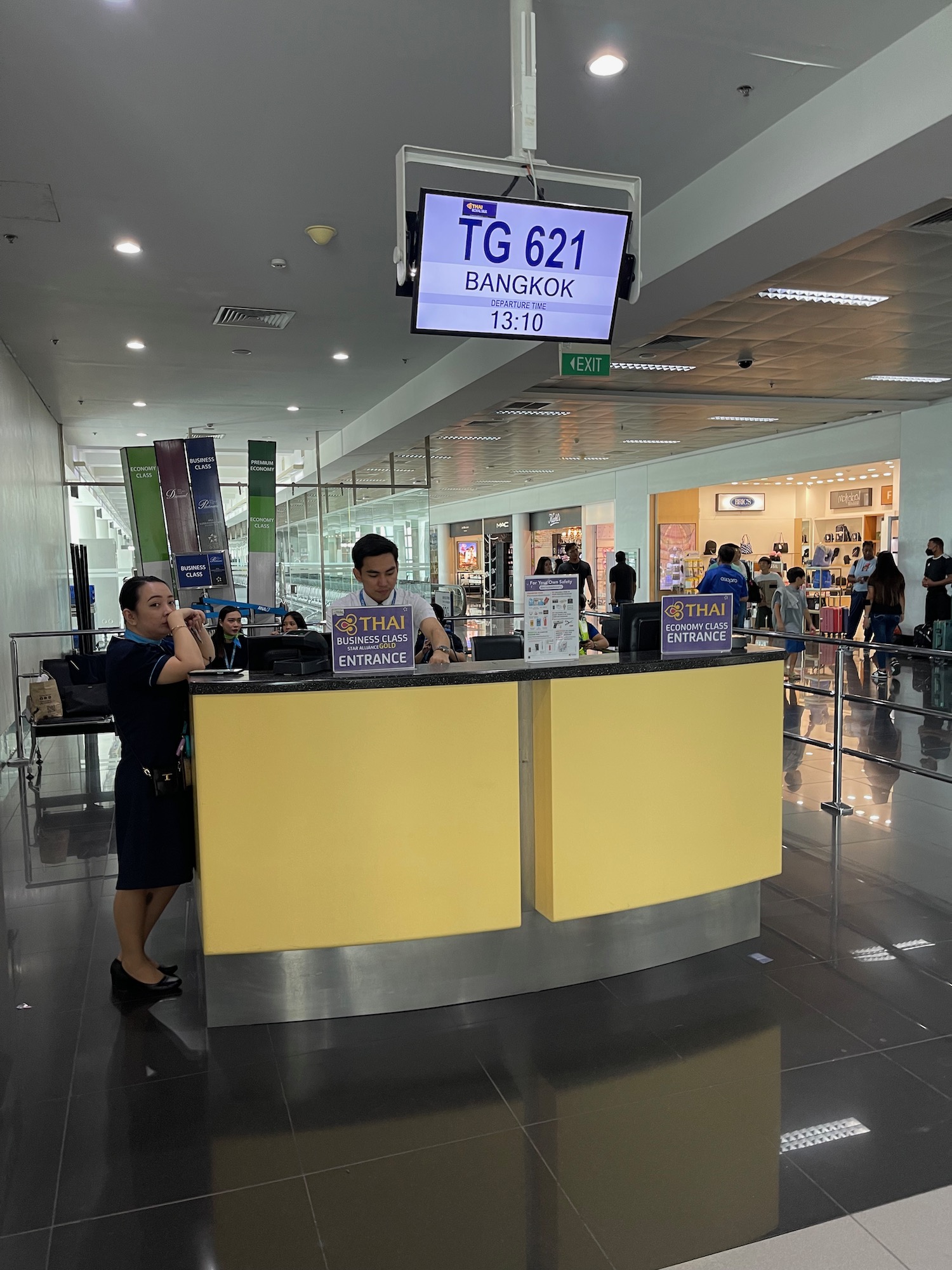 people standing at a counter in a building