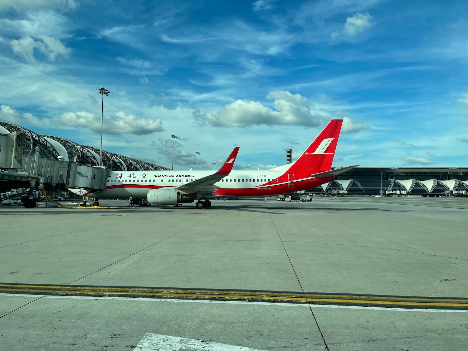 a red and white airplane on a runway