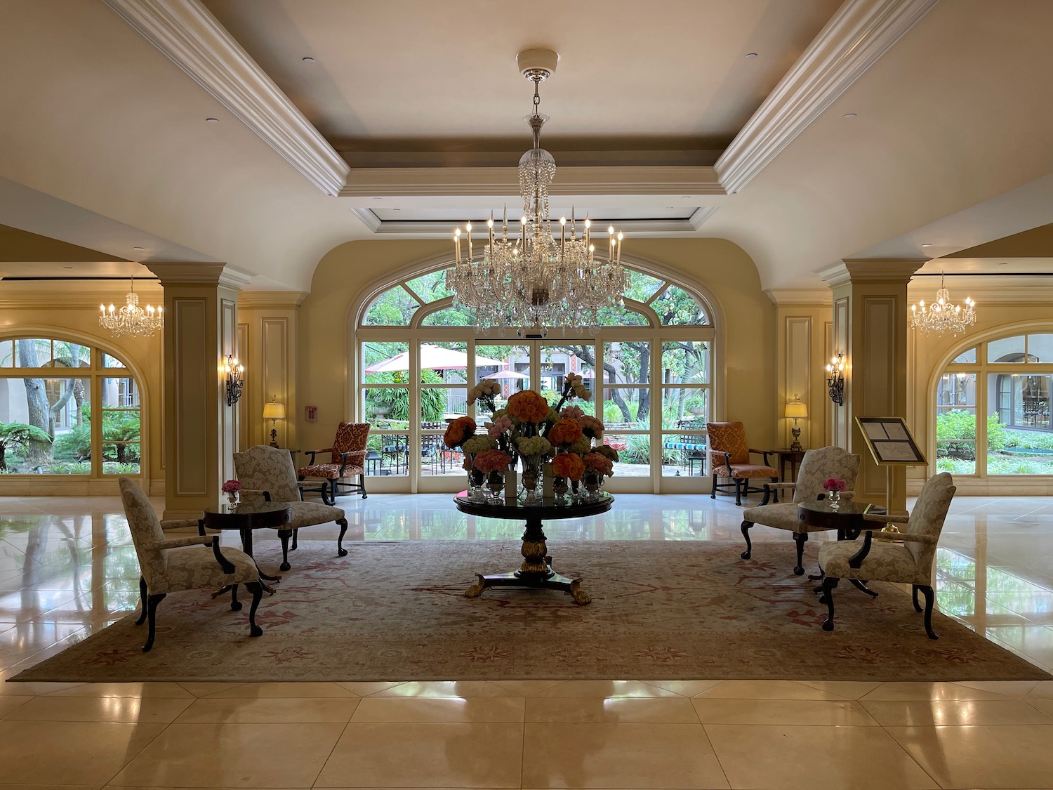 a room with chandelier and chairs