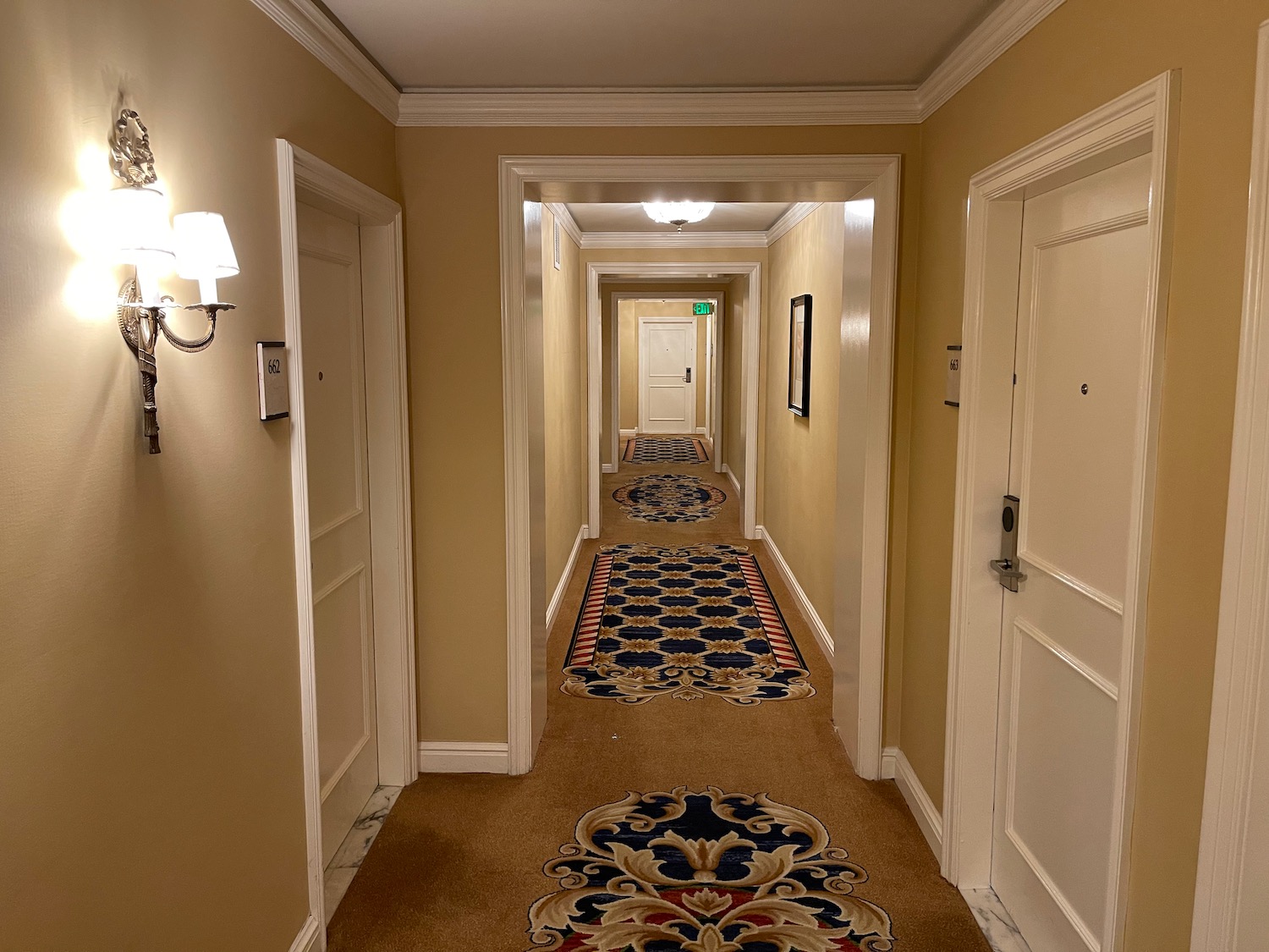 a hallway with carpet and doors