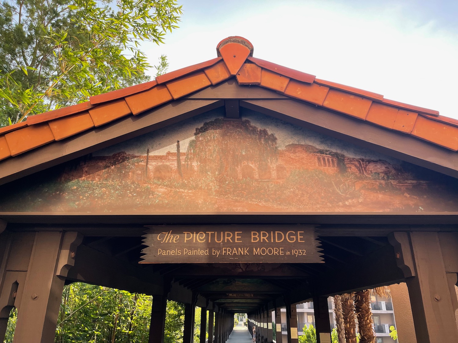 a covered bridge with a painting on it