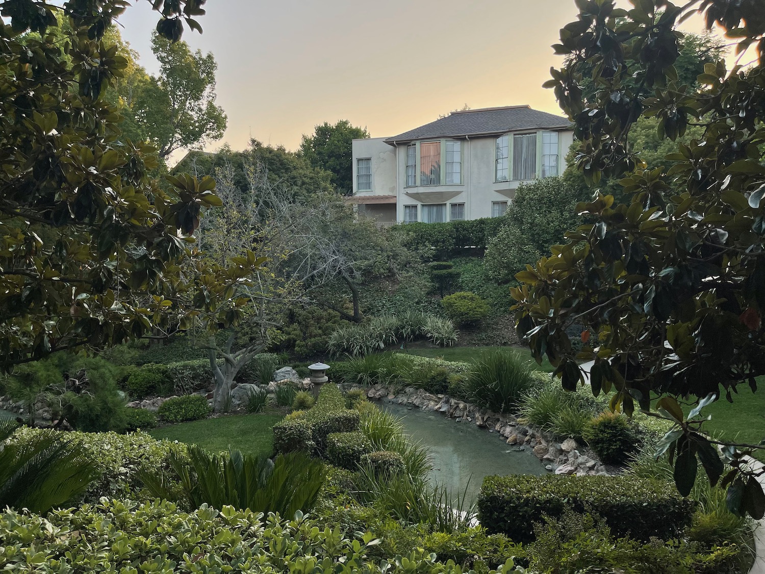 a house with a pond and trees