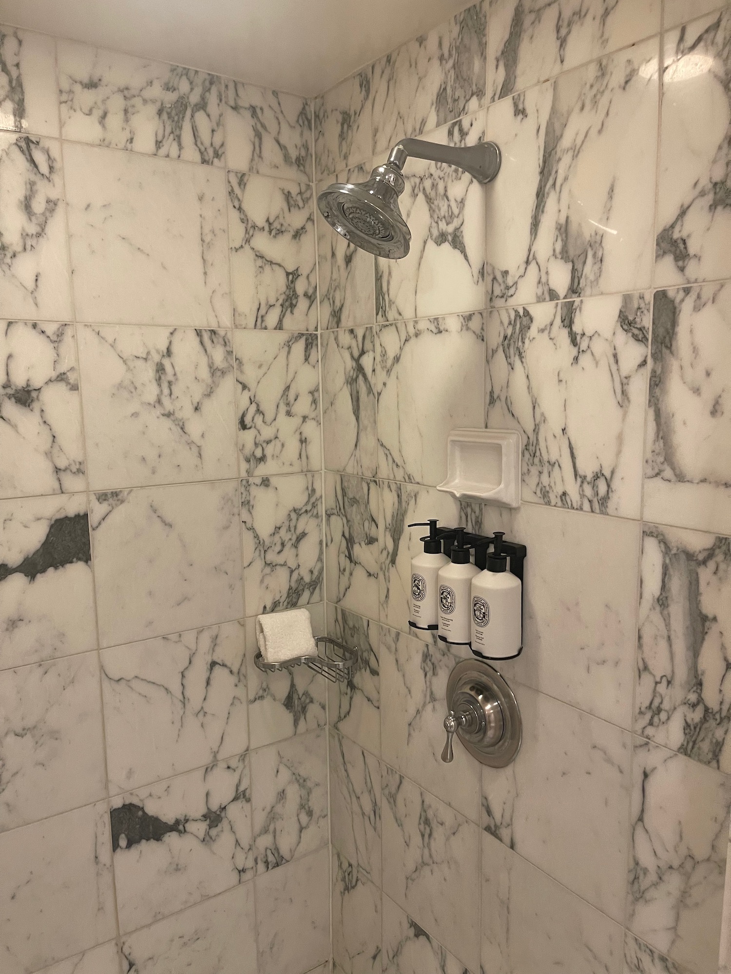 a shower with a shower head and a shower head