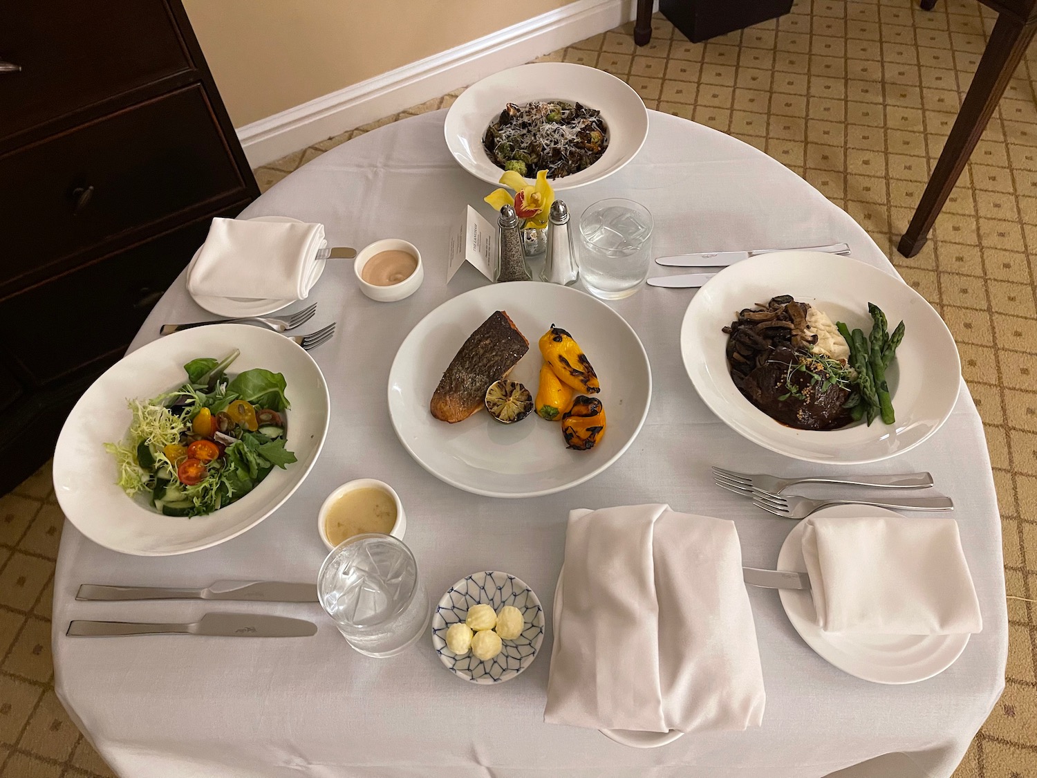 a table with plates of food and cutlery