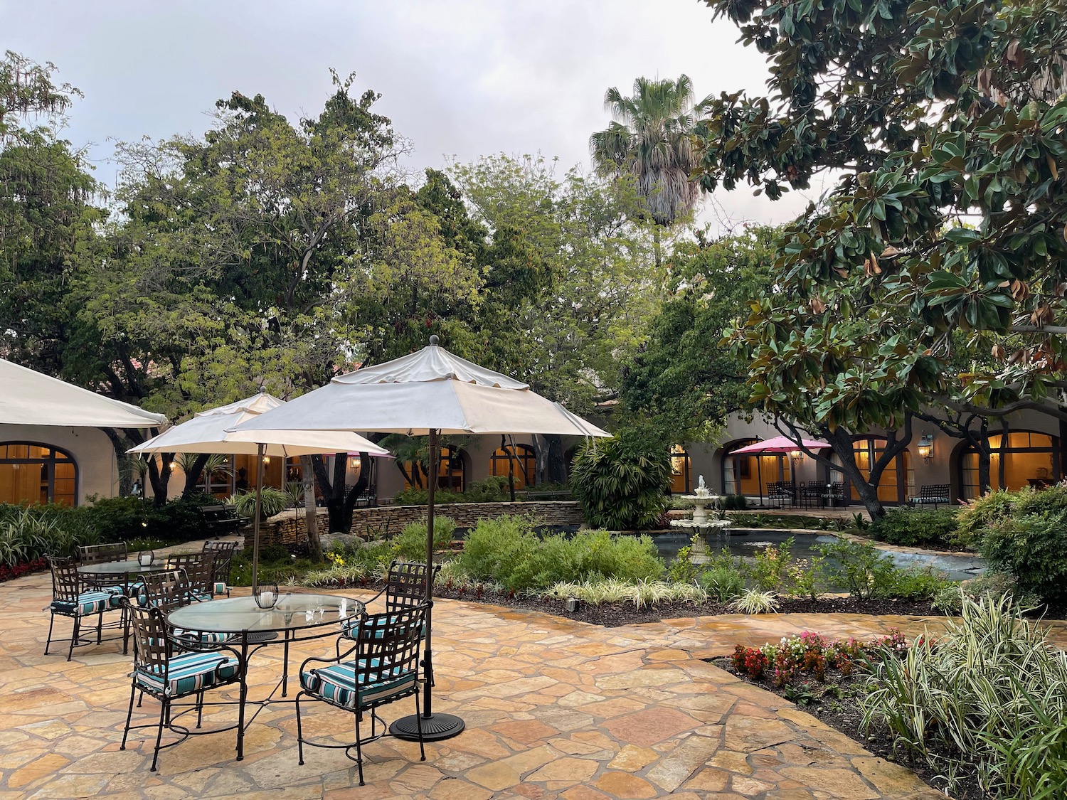 a patio with umbrellas and tables and chairs