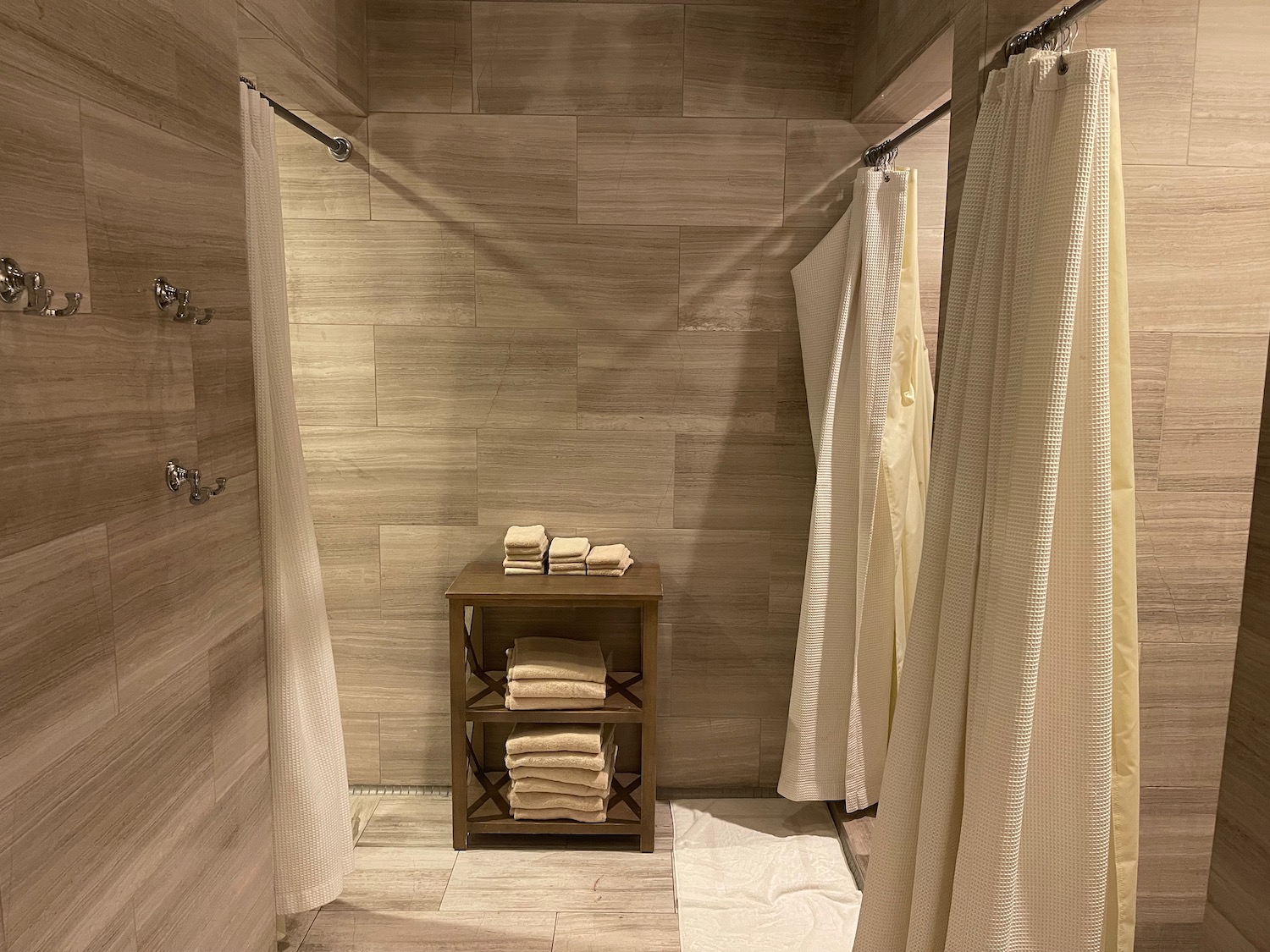 a shower with a shelf of towels