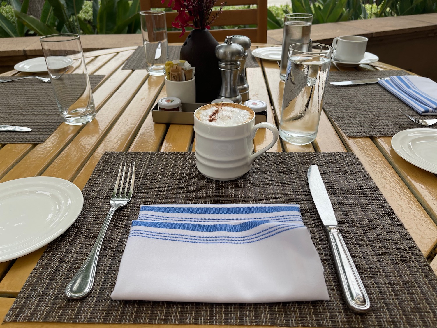 a table with utensils and a cup of coffee