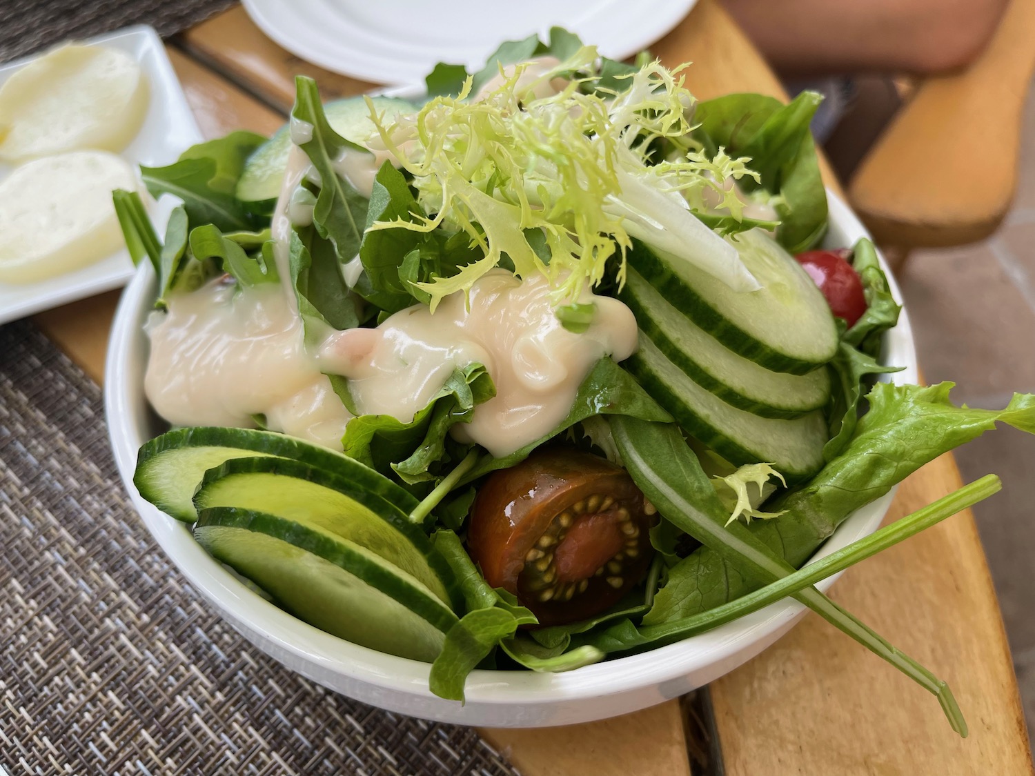 a bowl of salad with cucumbers and tomatoes