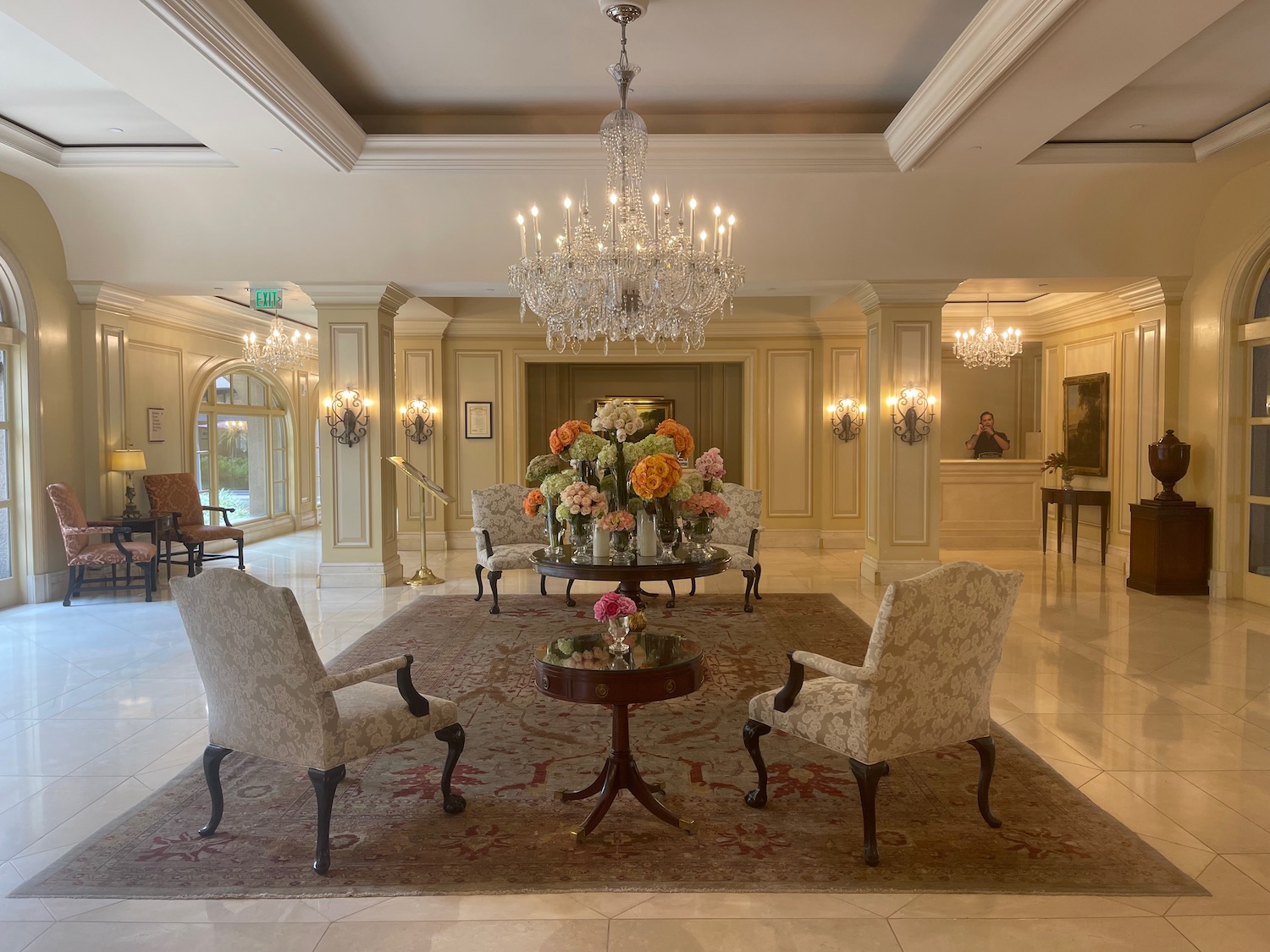 a room with chandeliers and chairs