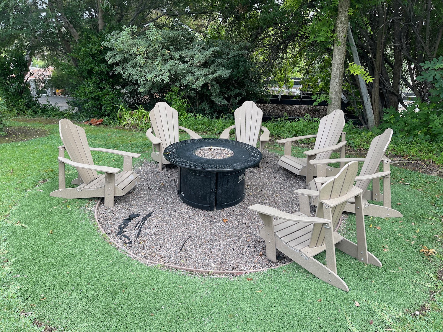 a fire pit surrounded by chairs