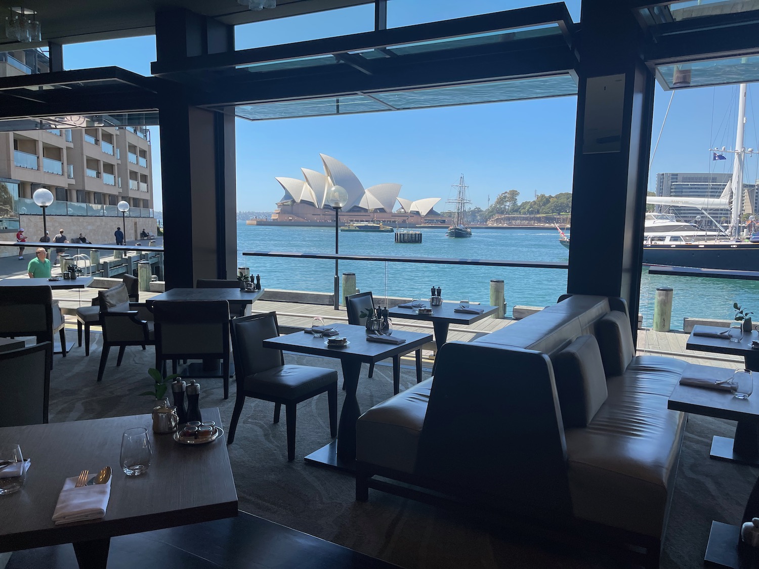 a restaurant with a view of the opera house and water