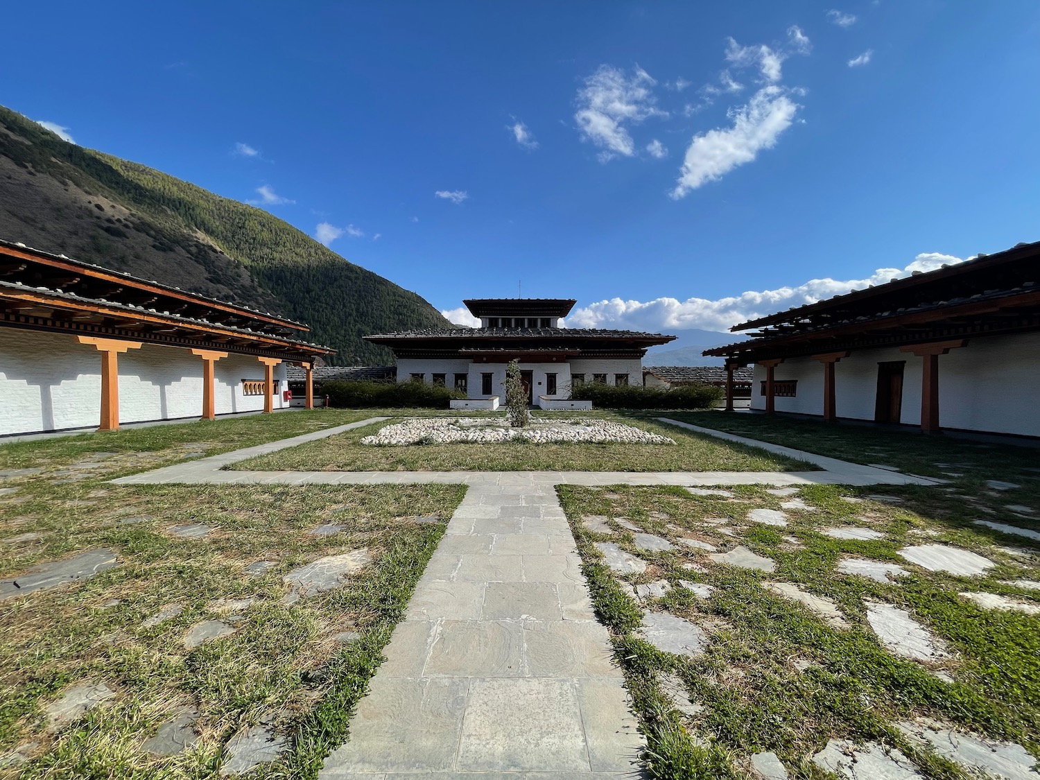 a building with a stone walkway and grass