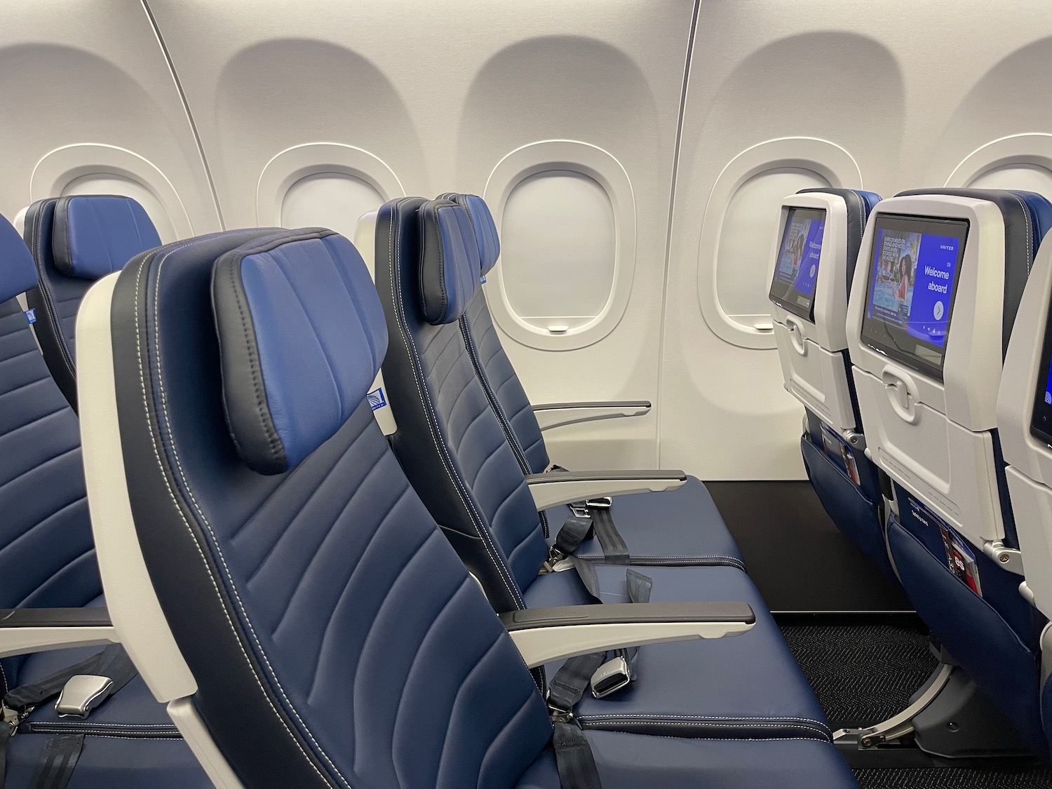 seats in an airplane with monitors