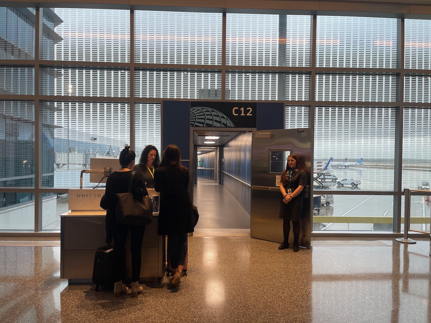 people standing in front of an airport counter