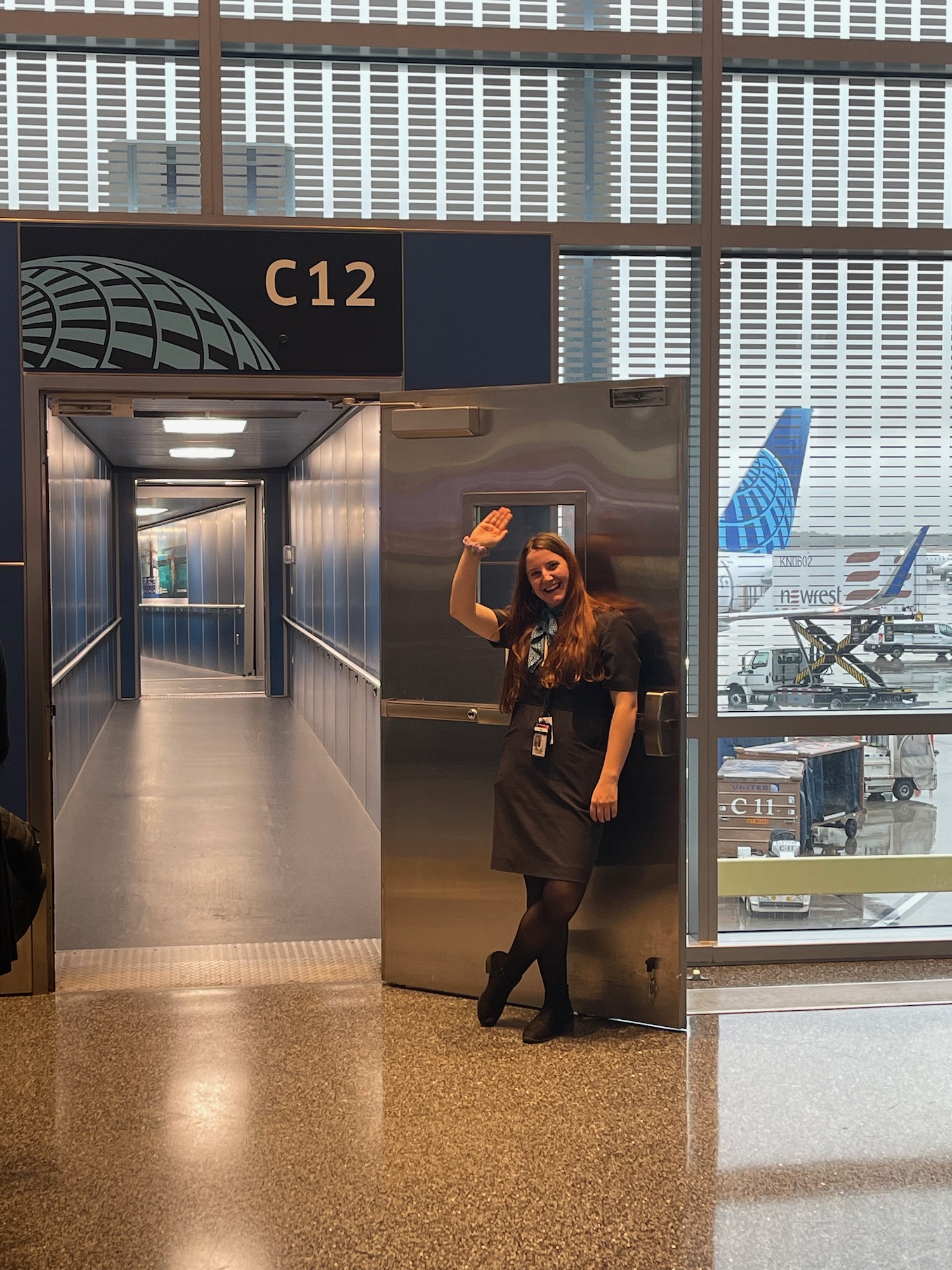 a woman waving in an airport