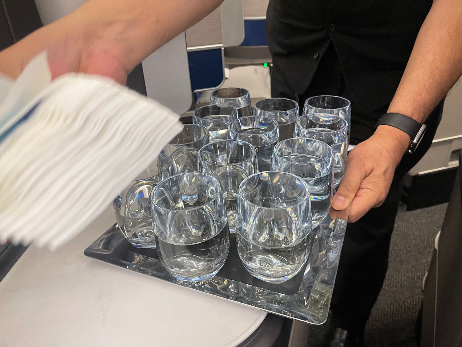 a tray of glasses and napkins