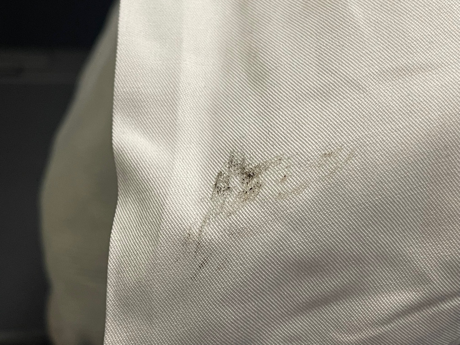 a close up of a white fabric with a stain on it