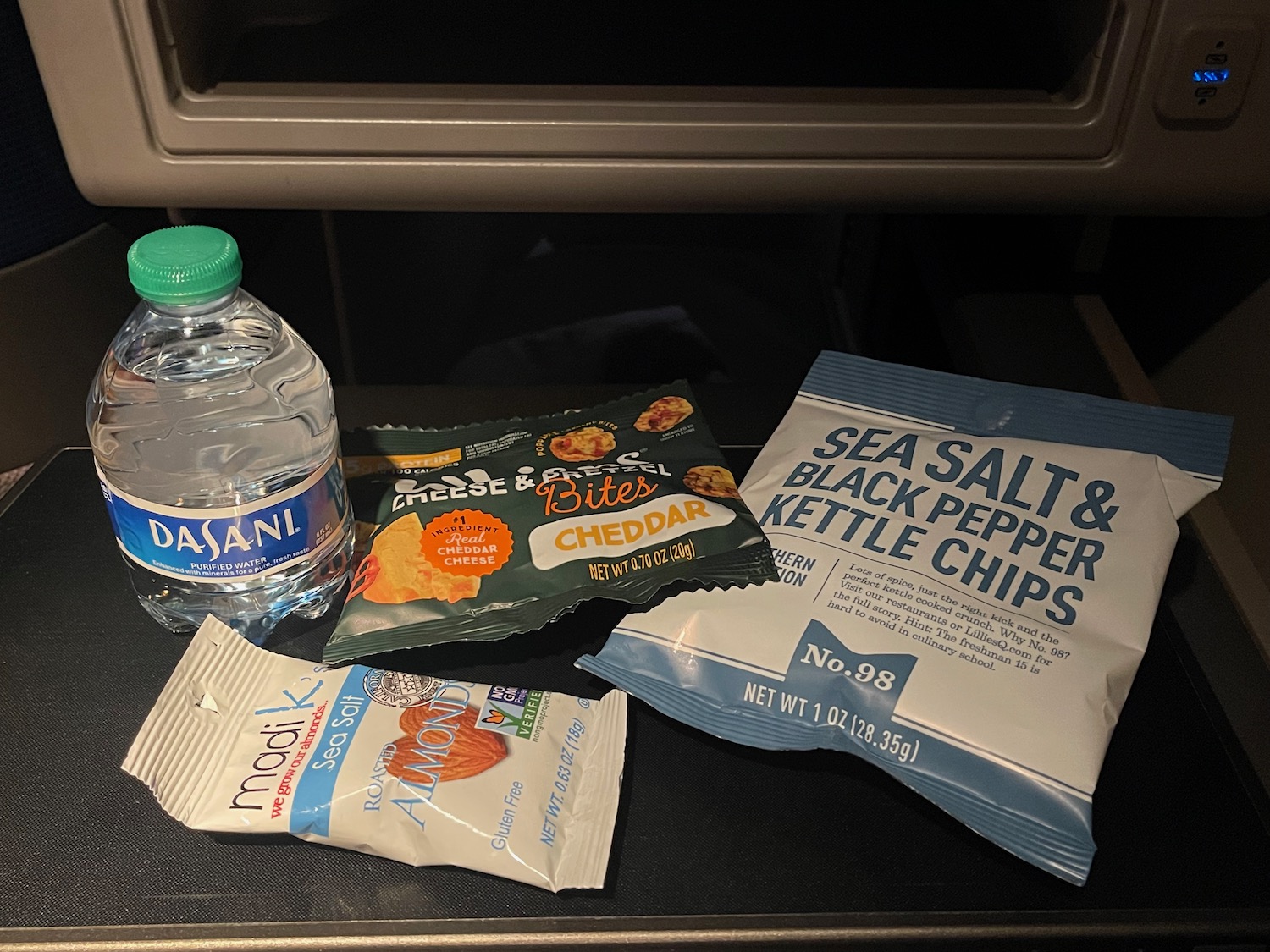 a bottle of water and snacks on a table