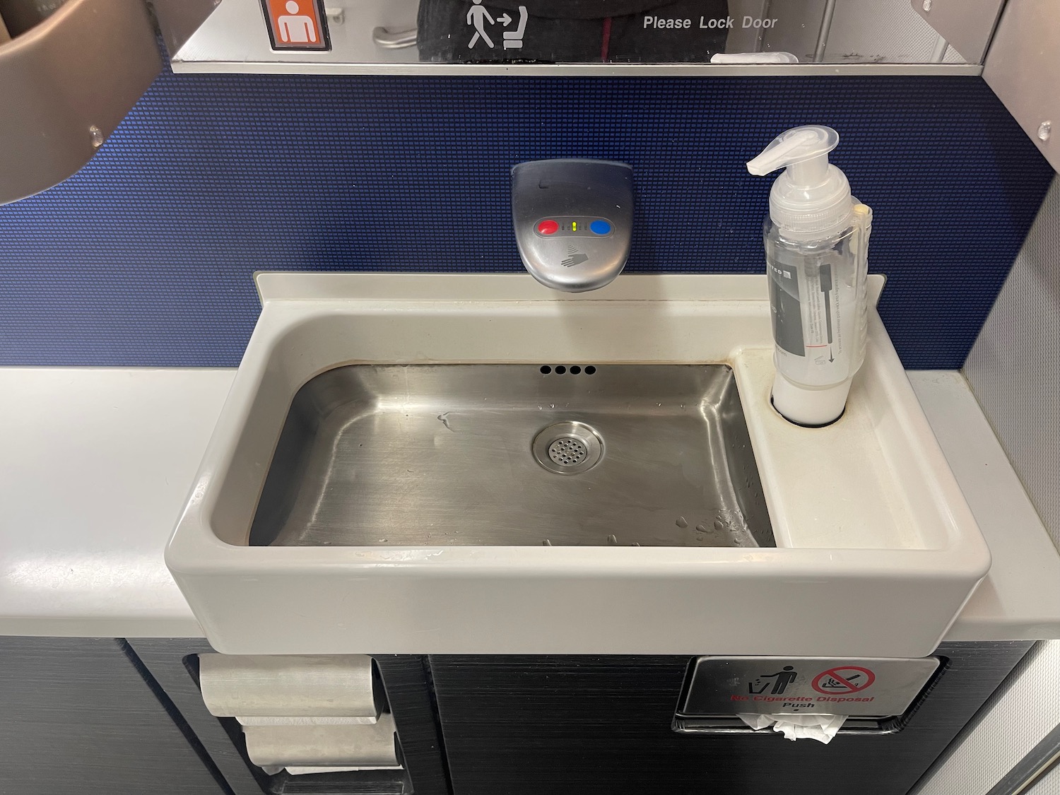 a sink with a bottle of soap on top