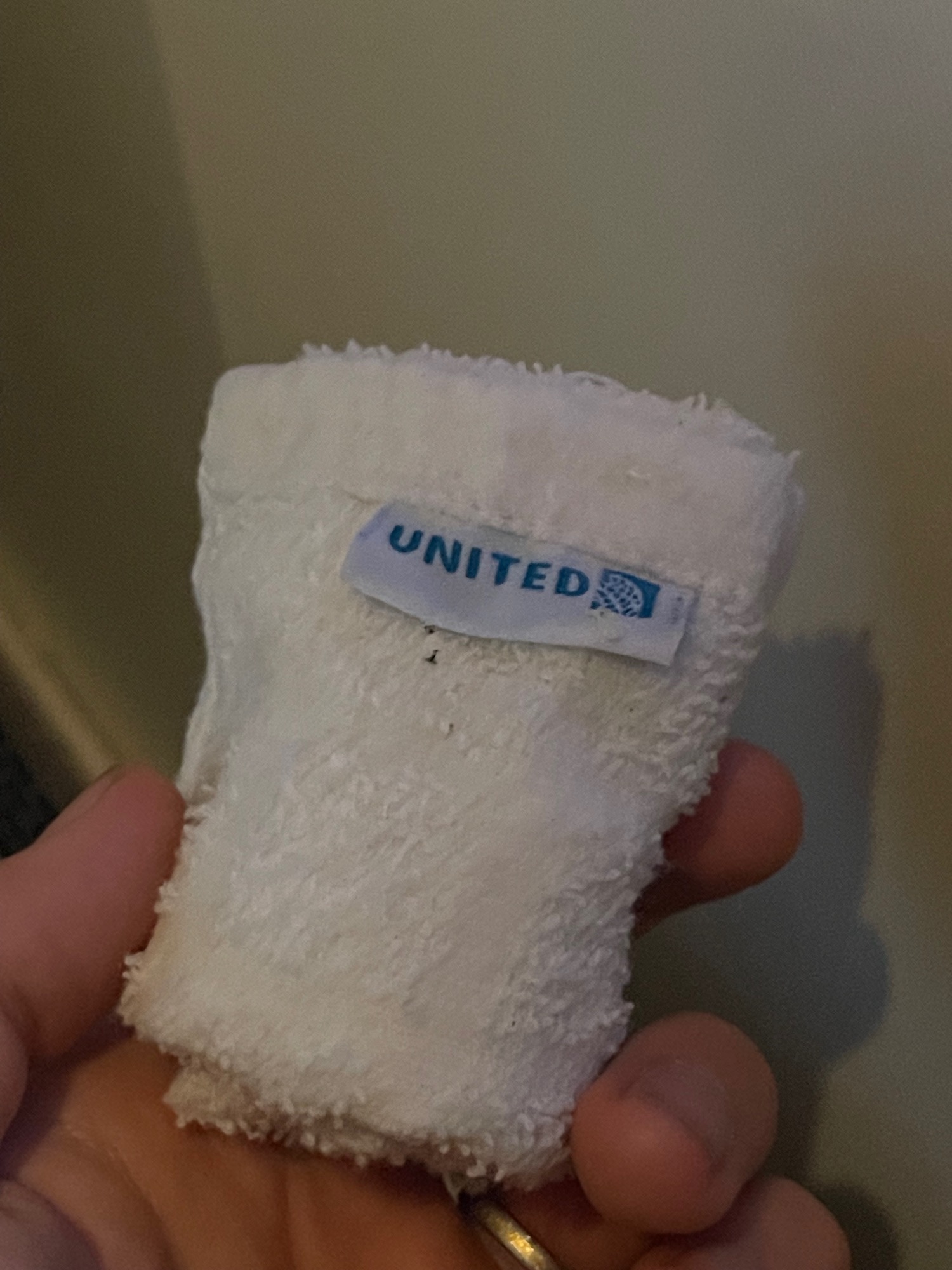 a hand holding a white towel