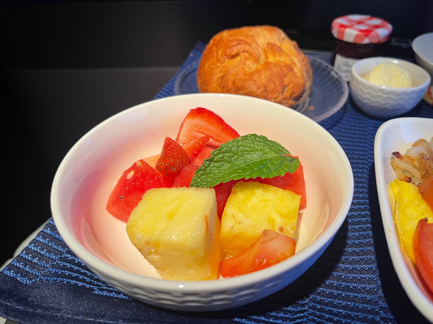 a bowl of fruit and a pastry