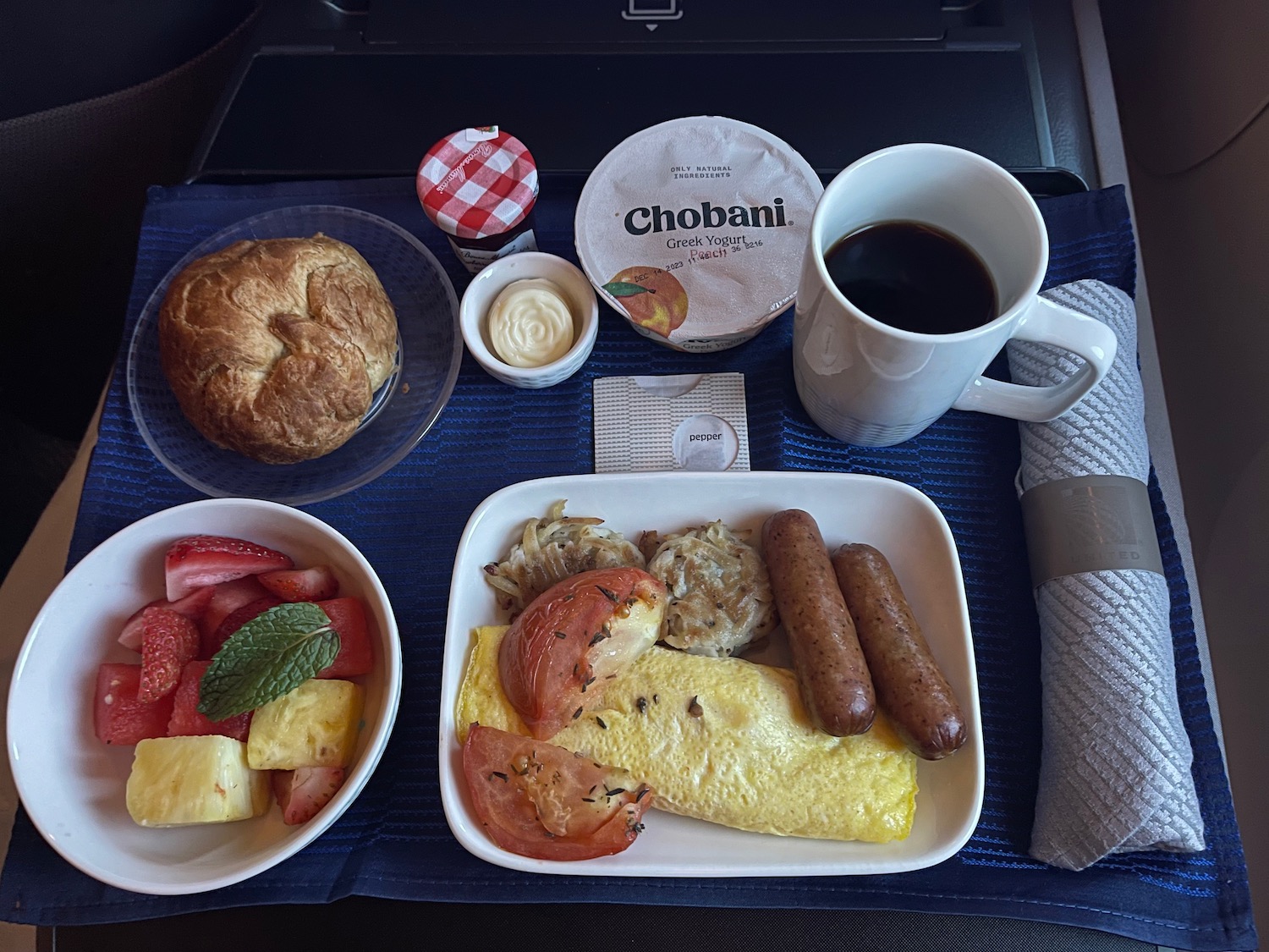 a tray of food and a cup of coffee on a tray