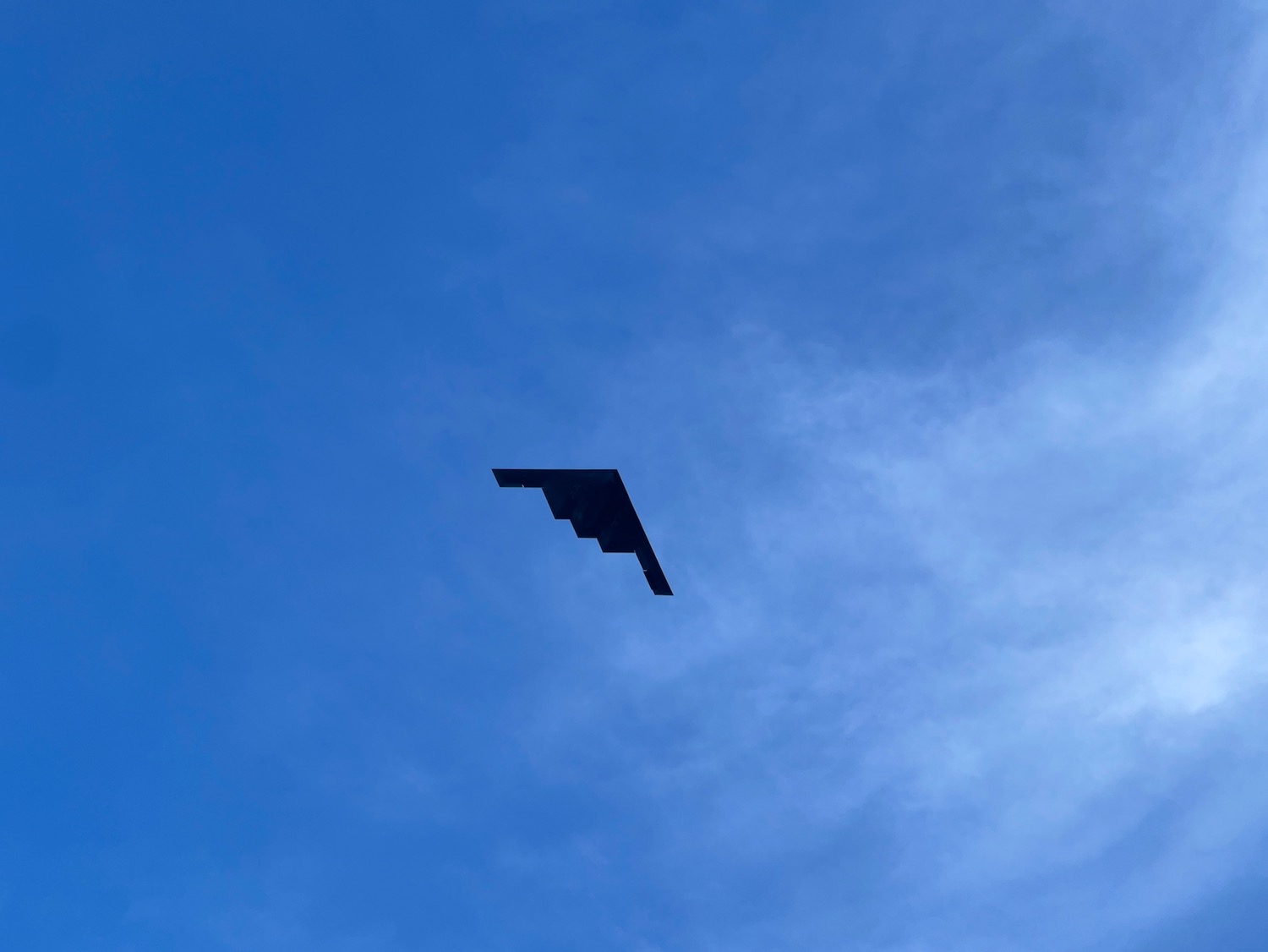 a black plane in the sky