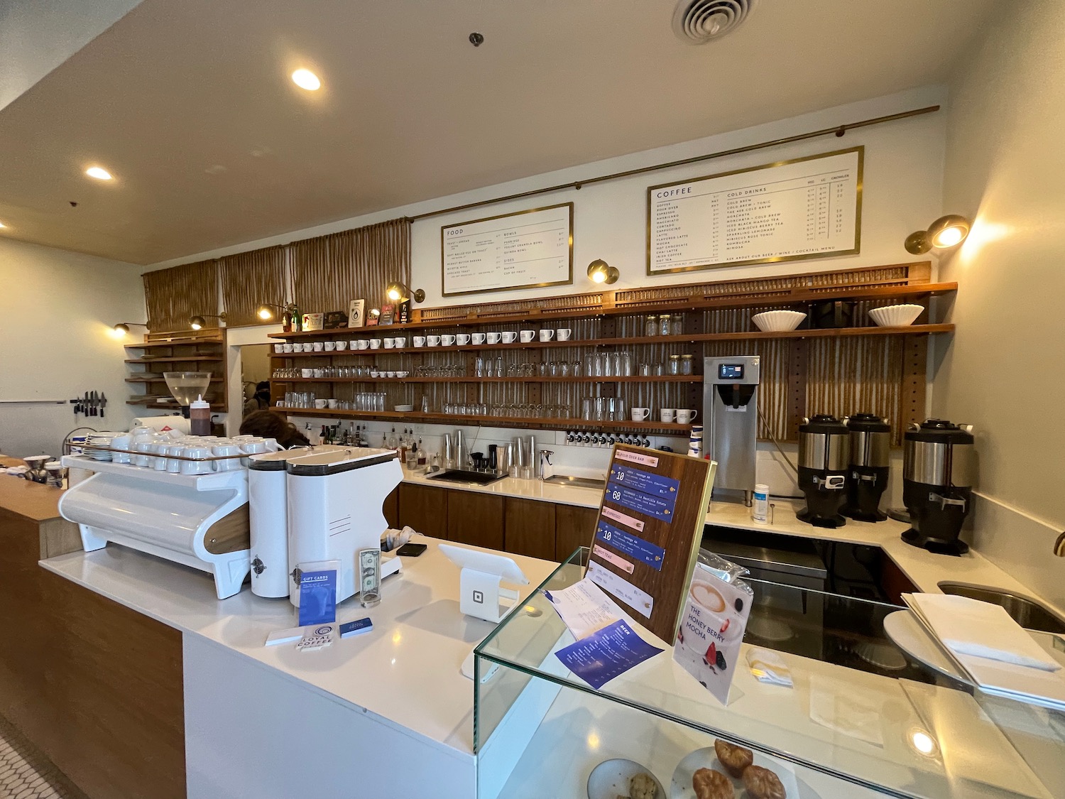 a coffee shop with a counter and shelves