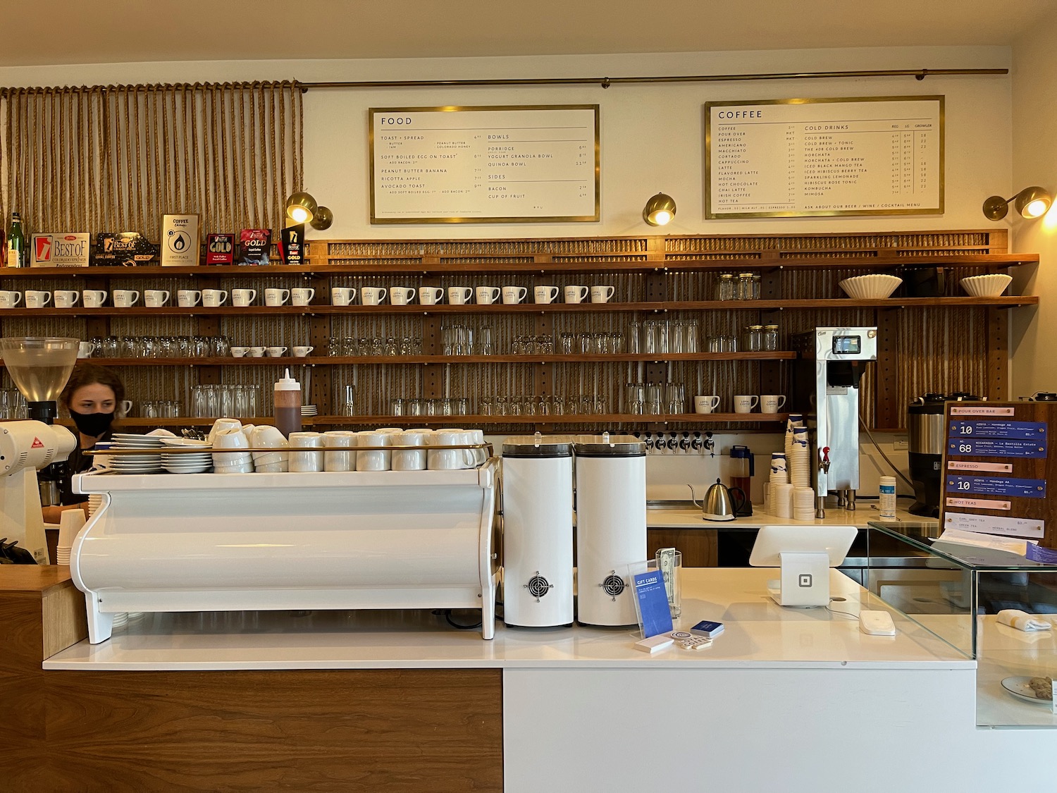 a coffee shop with a counter and shelves