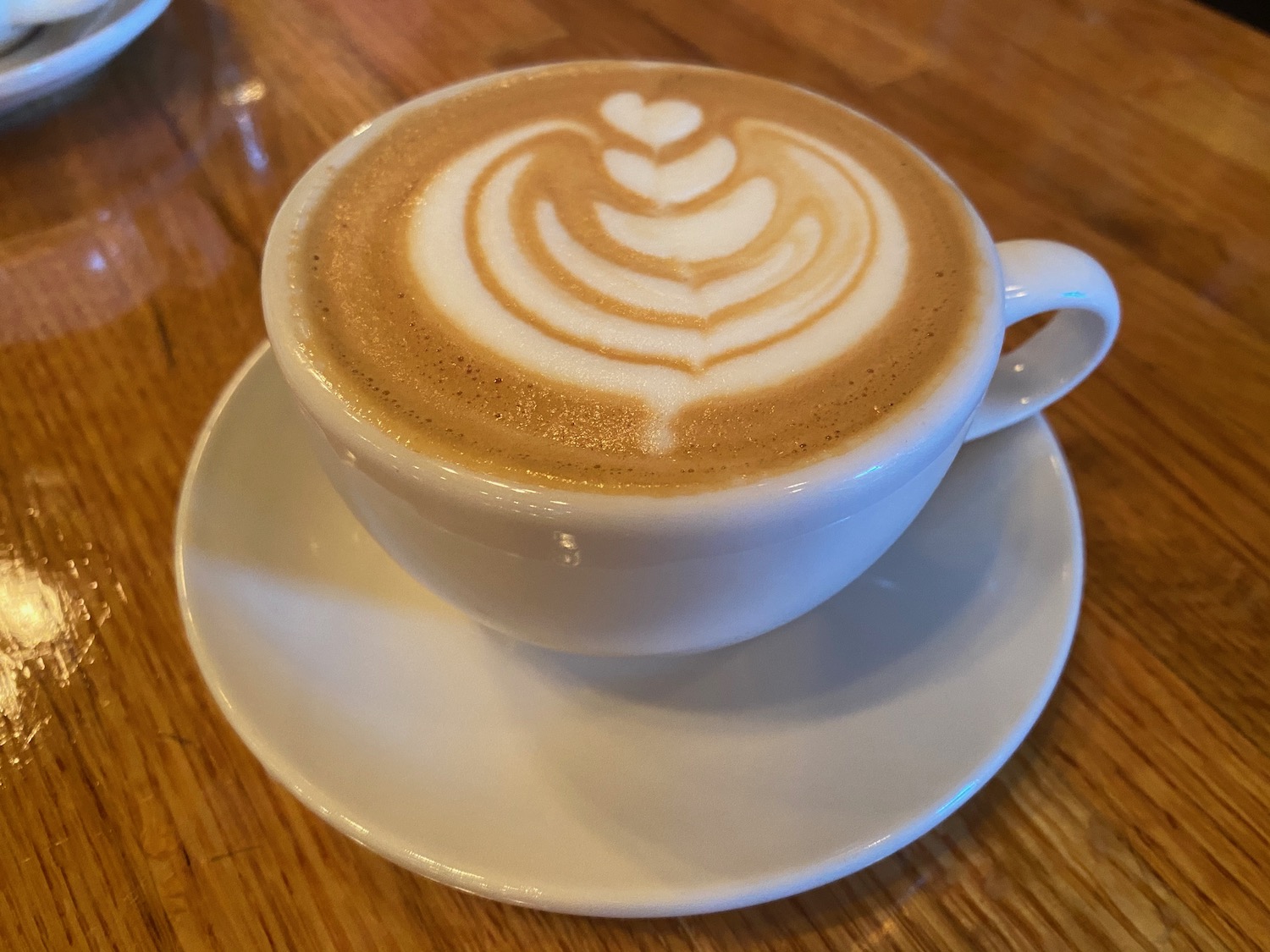 a cup of coffee with a heart design in the foam