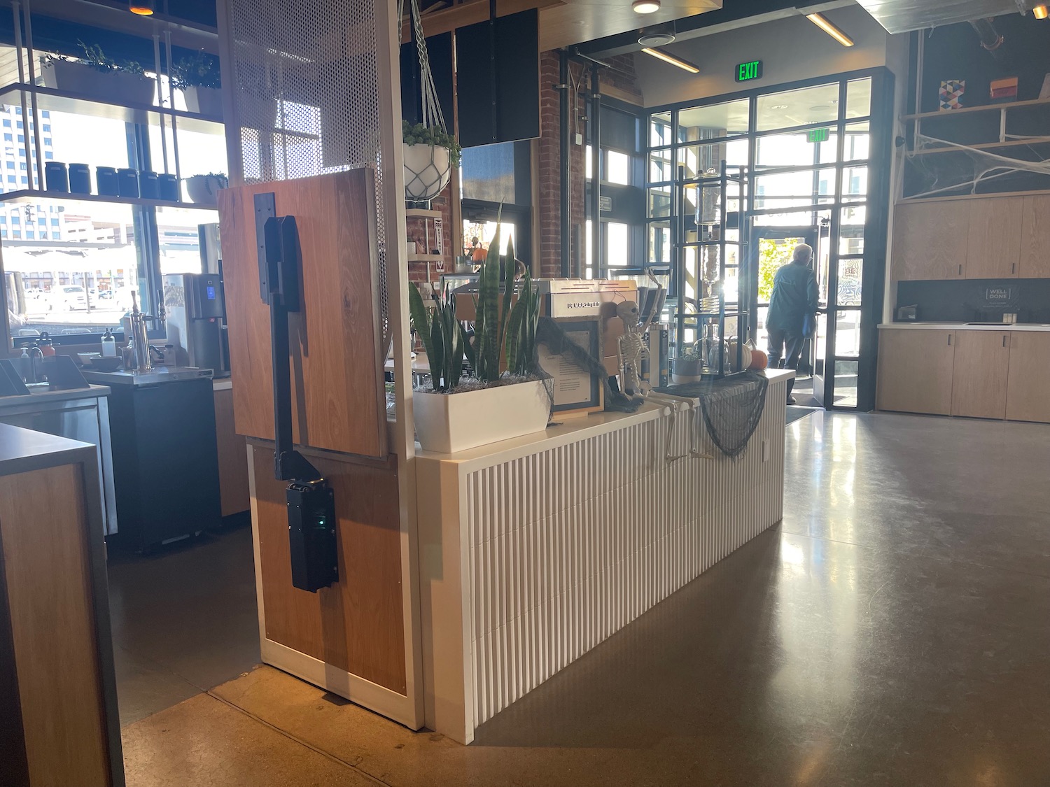 a counter with plants in front of a glass door