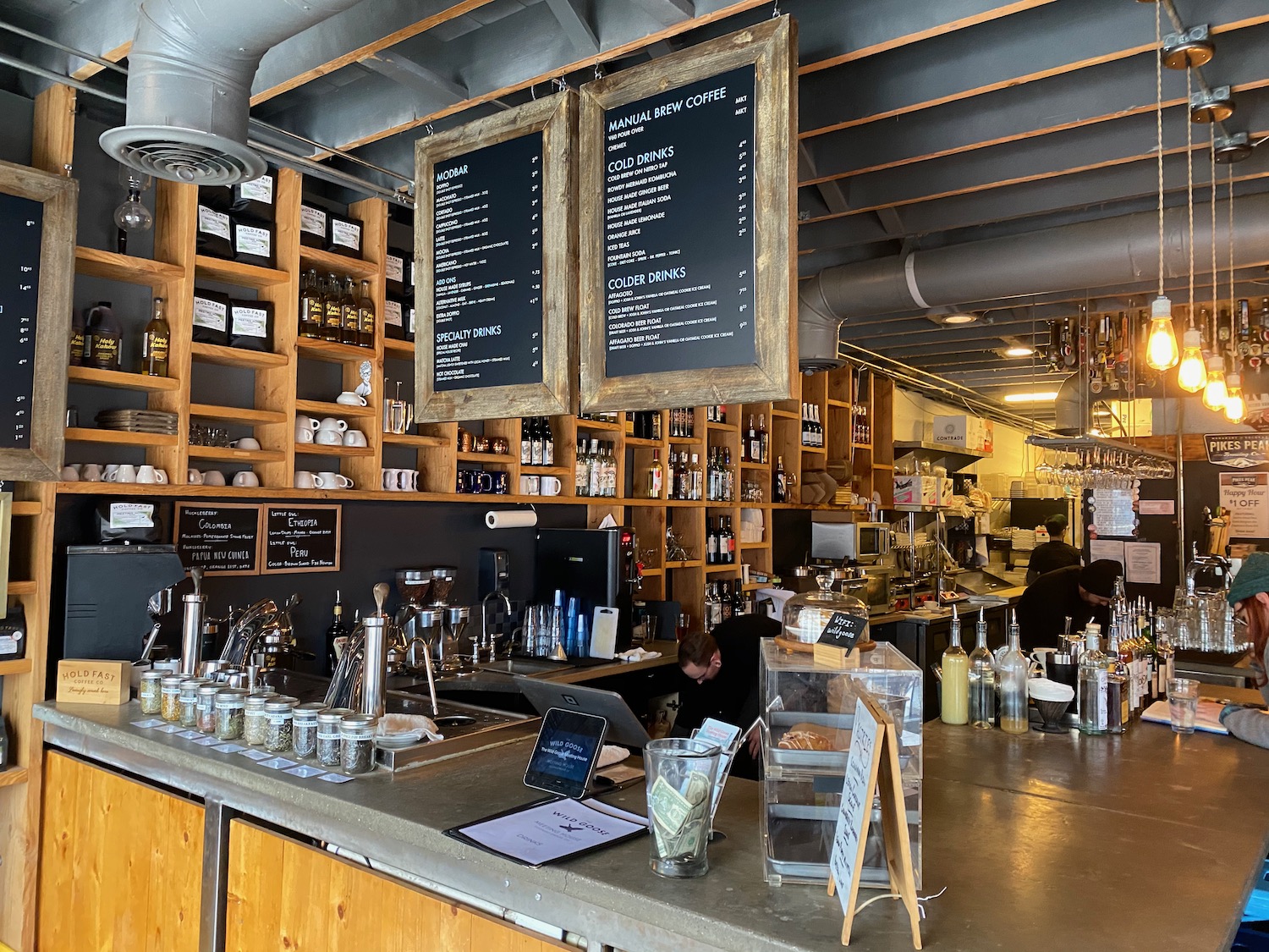 a bar with a menu and shelves of bottles