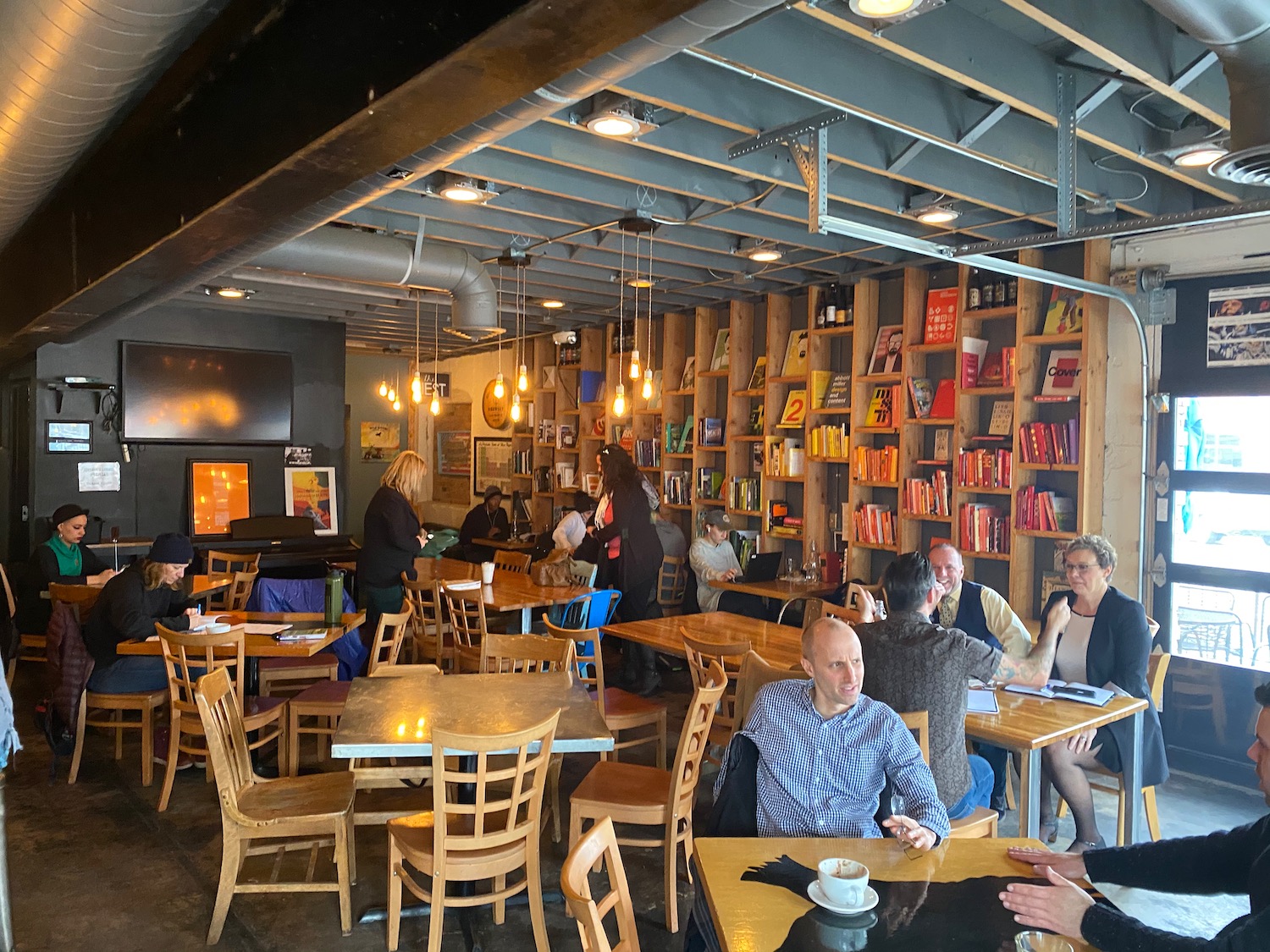 a group of people sitting at tables in a restaurant