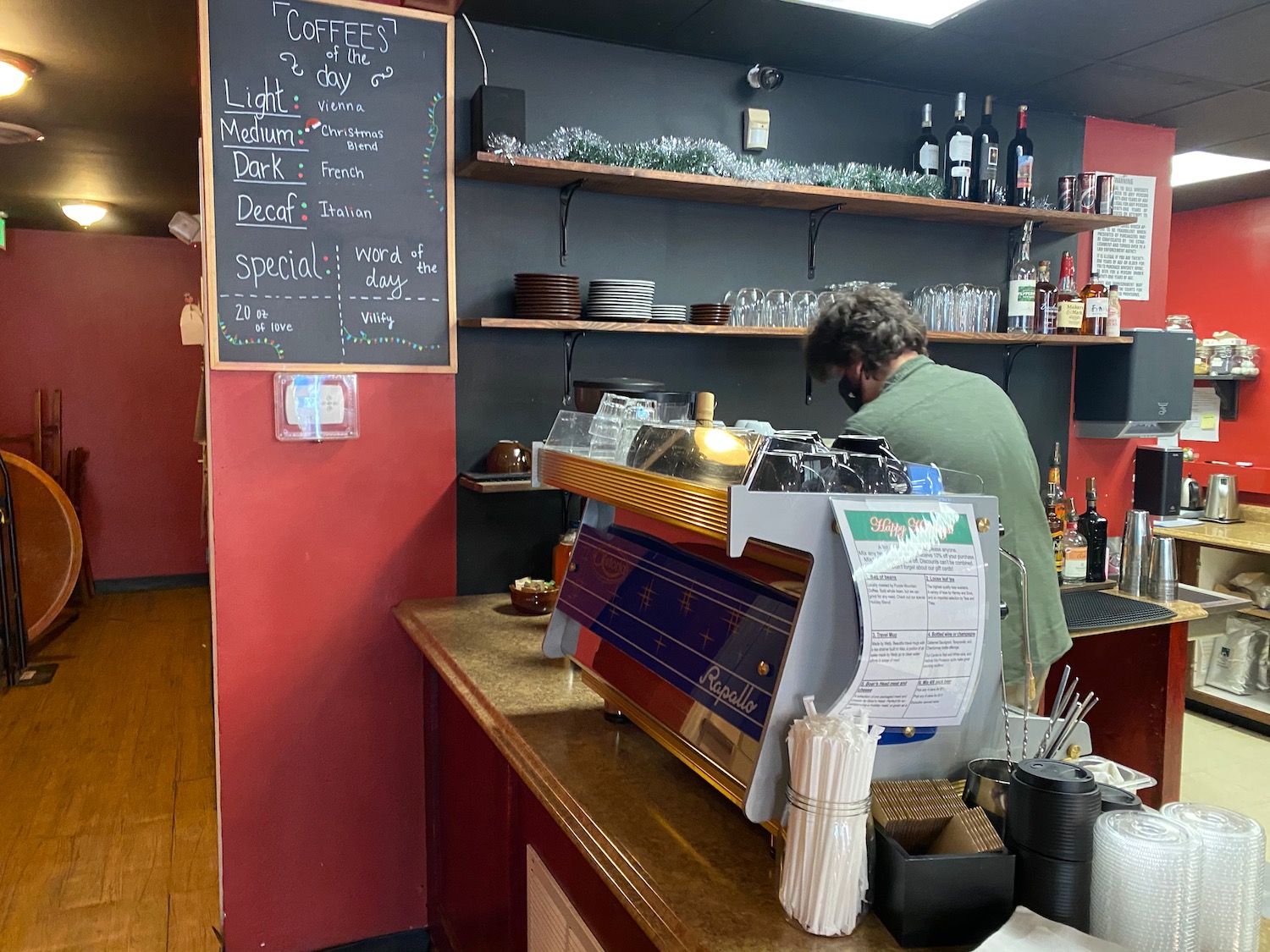 a man standing behind a counter in a restaurant