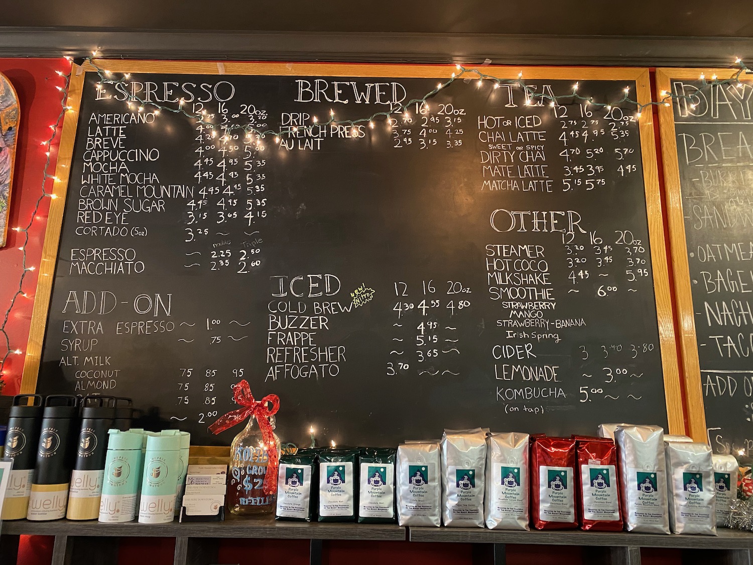 a chalkboard with a list of coffee and other items